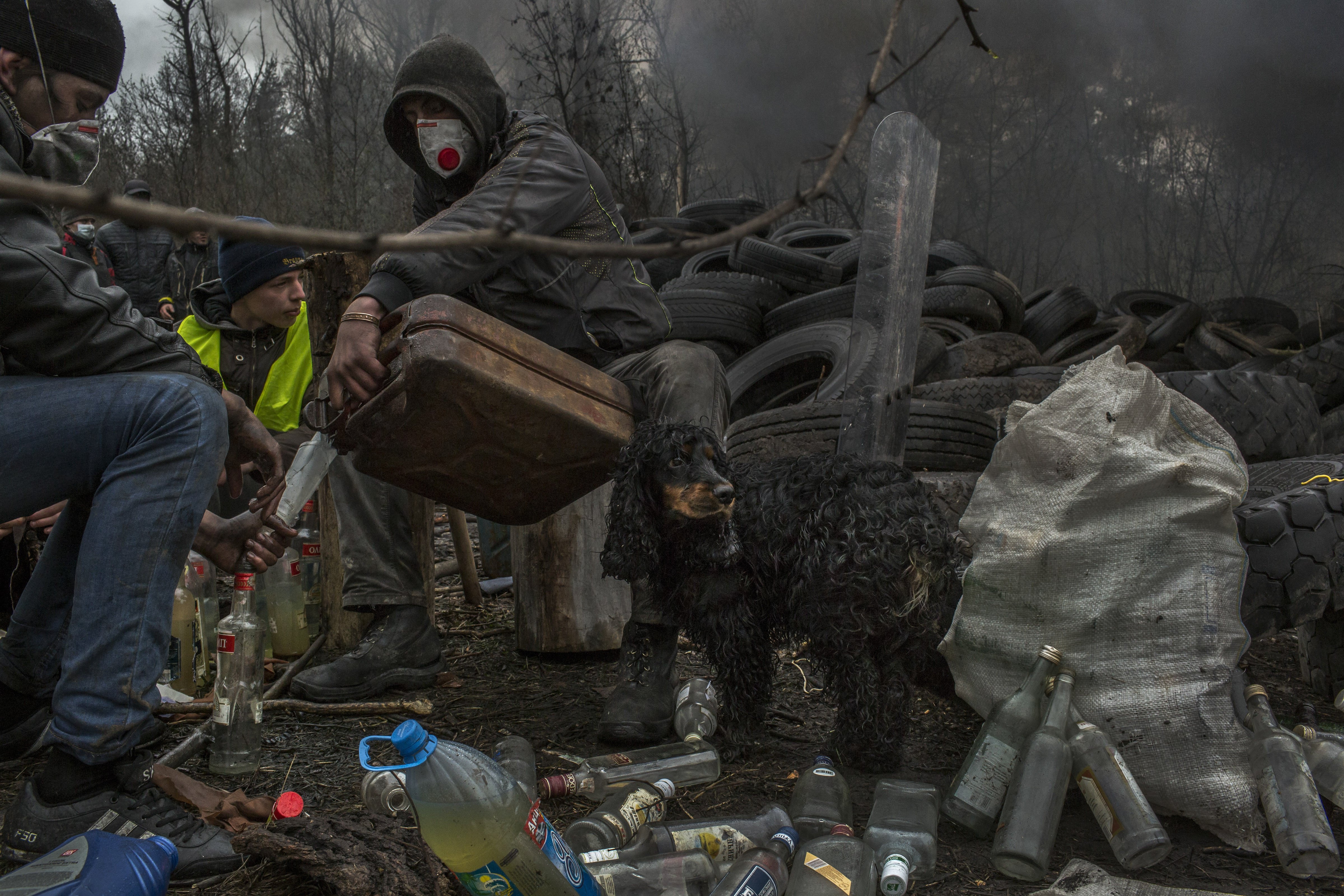 Apr. 13, 2014. Pro-Russian protesters prepare Molotov cocktails next to a barricade at one of the entrances to Slovyansk, Ukraine. A Ukrainian official said special forces on Sunday evicted gunmen from the Slovyansk Police Headquarters, but local residents and men at barricades denied that Ukrainian forces had even entered the town.