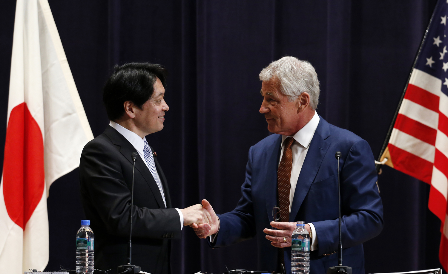 From right: U.S. Secretary of Defense Chuck Hagel shakes hands with his Japanese counterpart Itsunori Onodera at the end of their joint news conference at the Defense Ministry in Tokyo on April 6, 2014. (Issei Kato—Reuters)