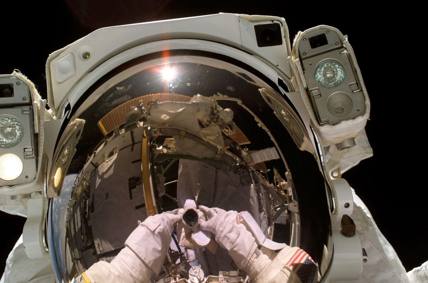 NASA astronaut Heidemarie M. Stefanyshyn-Piper, STS-115 mission specialist, takes a self-portrait during a space walk, on Sept. 12, 2006.
