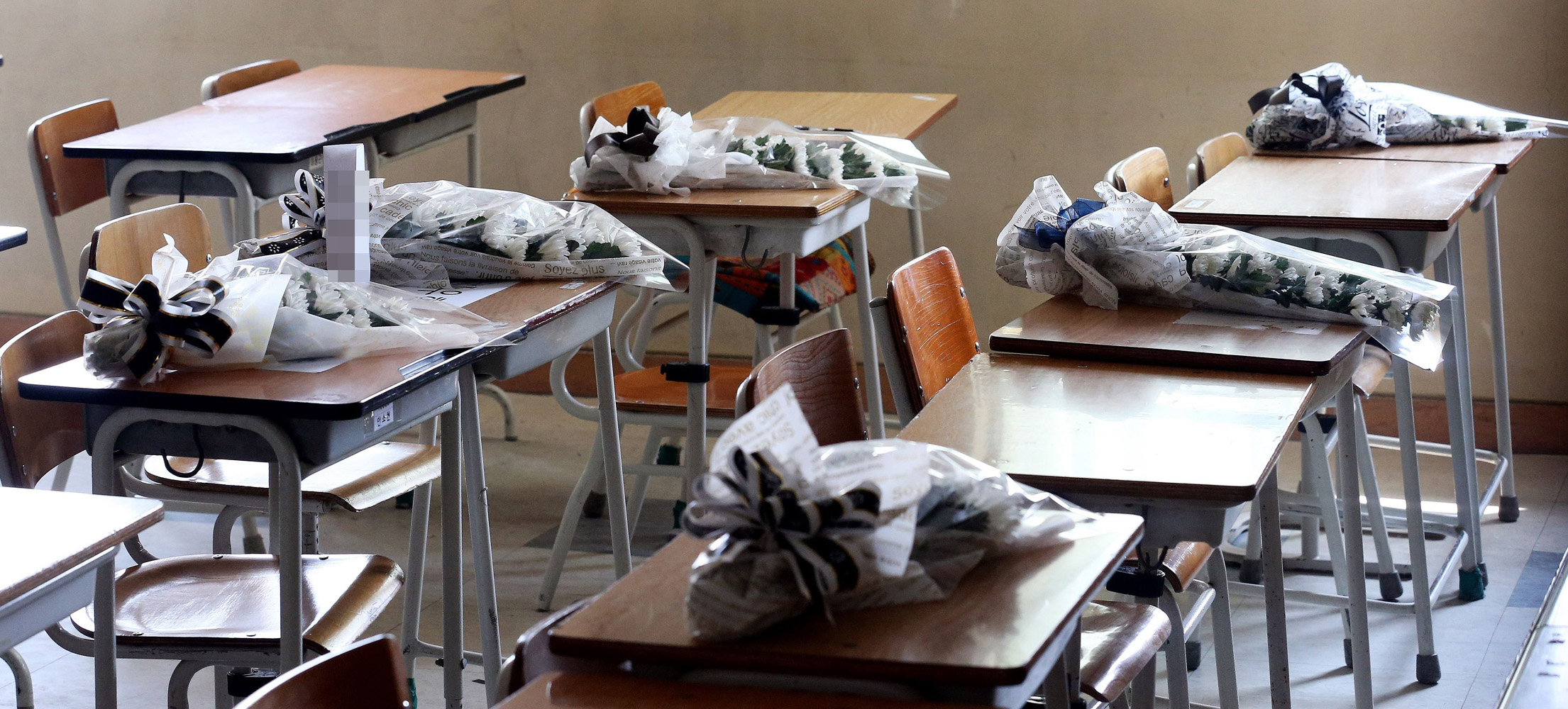 Apr. 23, 2014. Flowers are seen on the desks of students killed in the sunken South Korean ferry 'Sewol', at a classroom of Danwon high school in Ansan.