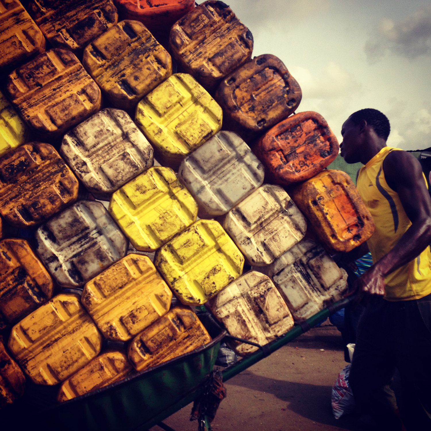 Apr. 6, 2014. Lagos hustle: pushing plastic cans of palm oil at Mile 12 market