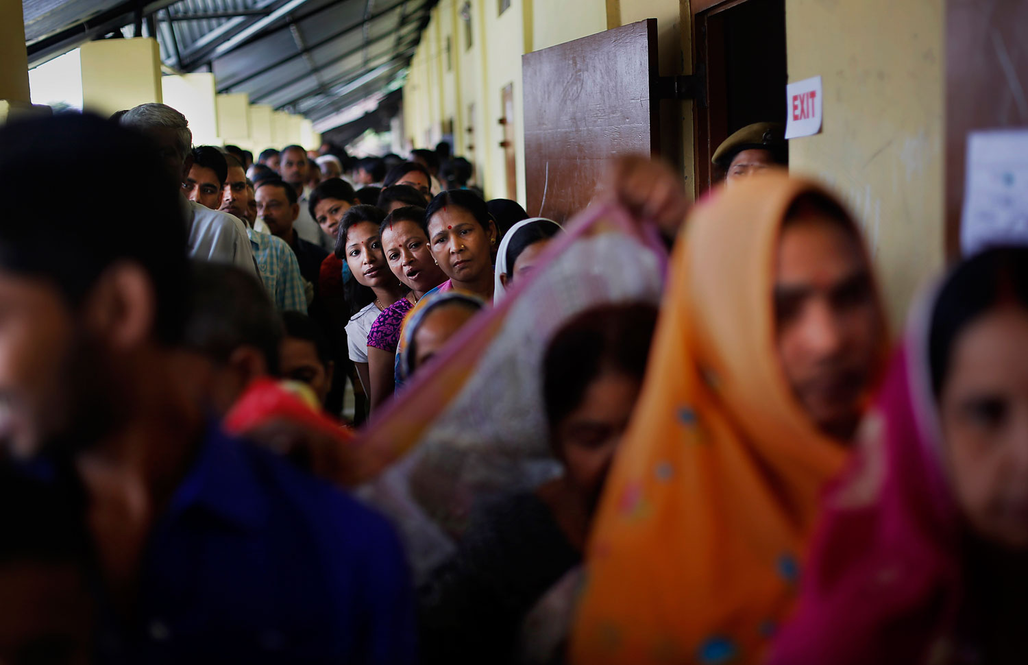 Indian voters wait in queues to cast their votes during the first phase of elections in Dibrugarh, in the northeastern state of Assam, India, April 7, 2014.