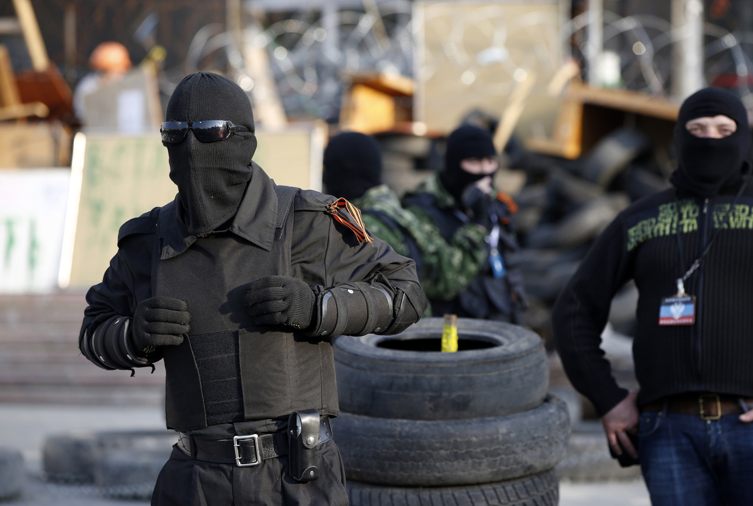 Masked pro-Russia protesters stand guard outside a regional government building in Donetsk