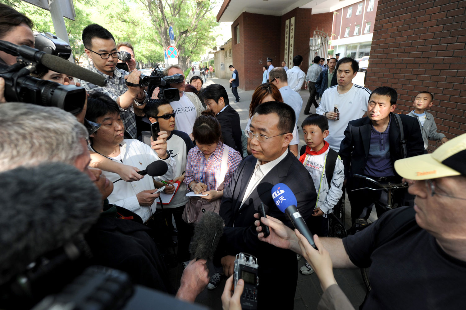 Journalists interview Chinese rights lawyer Jiang Tianyong at a gate of the Chaoyang hospital in Beijing in Beijing on May 2, 2012. (Mark Ralston—AFP/Getty Images)