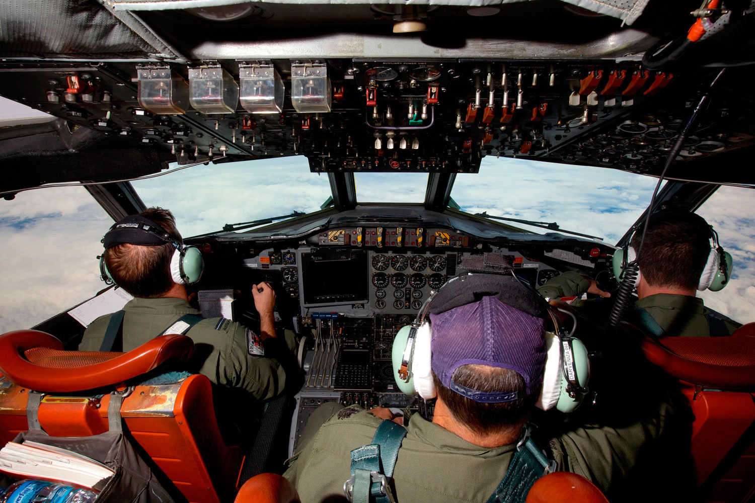 Co-Pilot Flying Officer Marc Smith (L) and crewmen fly at high altitude aboard a Royal Australian Air Force (RAAF) AP-3C Orion aircraft after searching for the missing Malaysian Airlines Flight MH370 over the southern Indian Ocean March 24, 2014. (Richard Wainwright—Reuters)