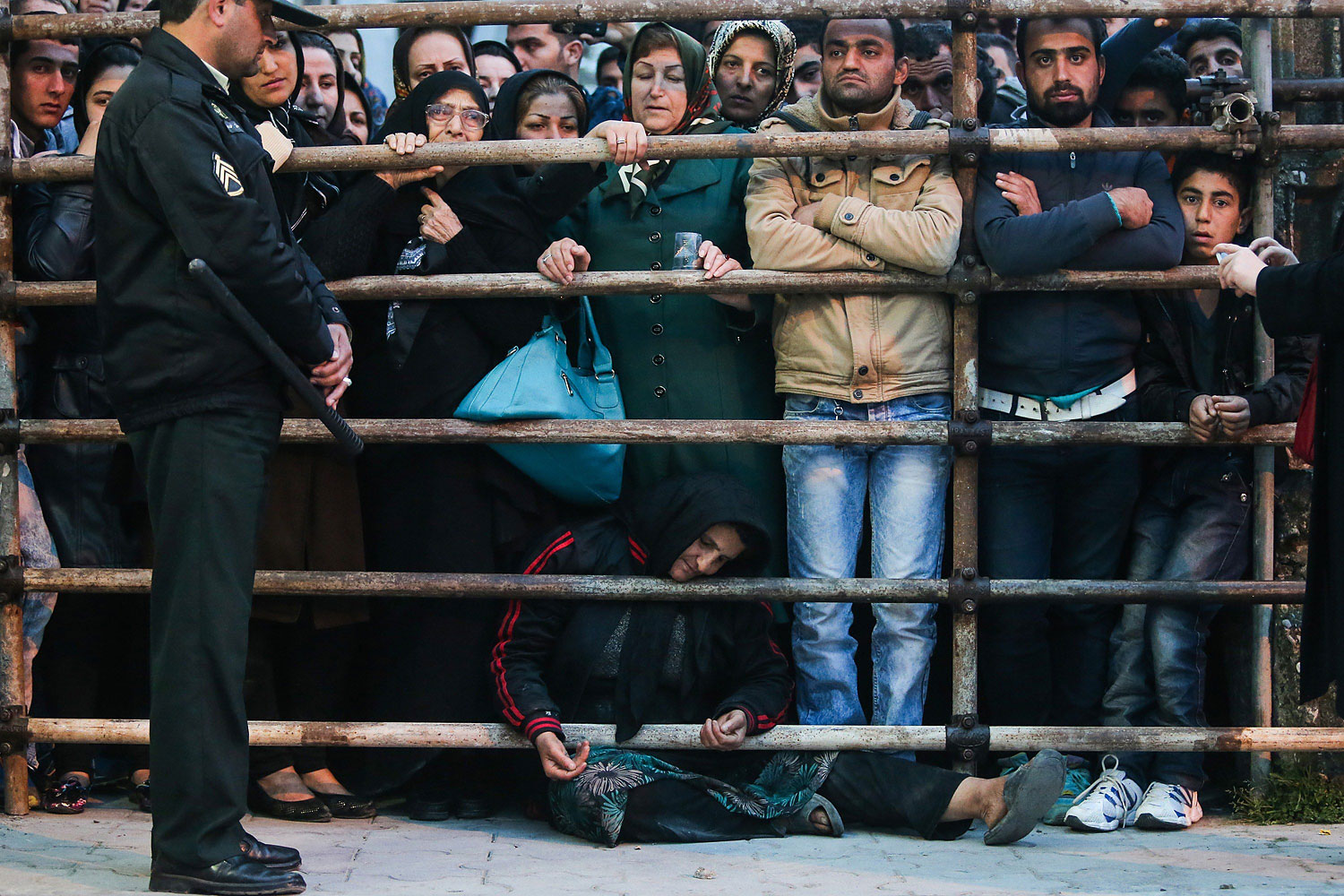 The mother of Balal asks for the family's forgiveness as her son is brought to the gallows during his execution ceremony in the northern city of Nowshahr on April 15, 2014.