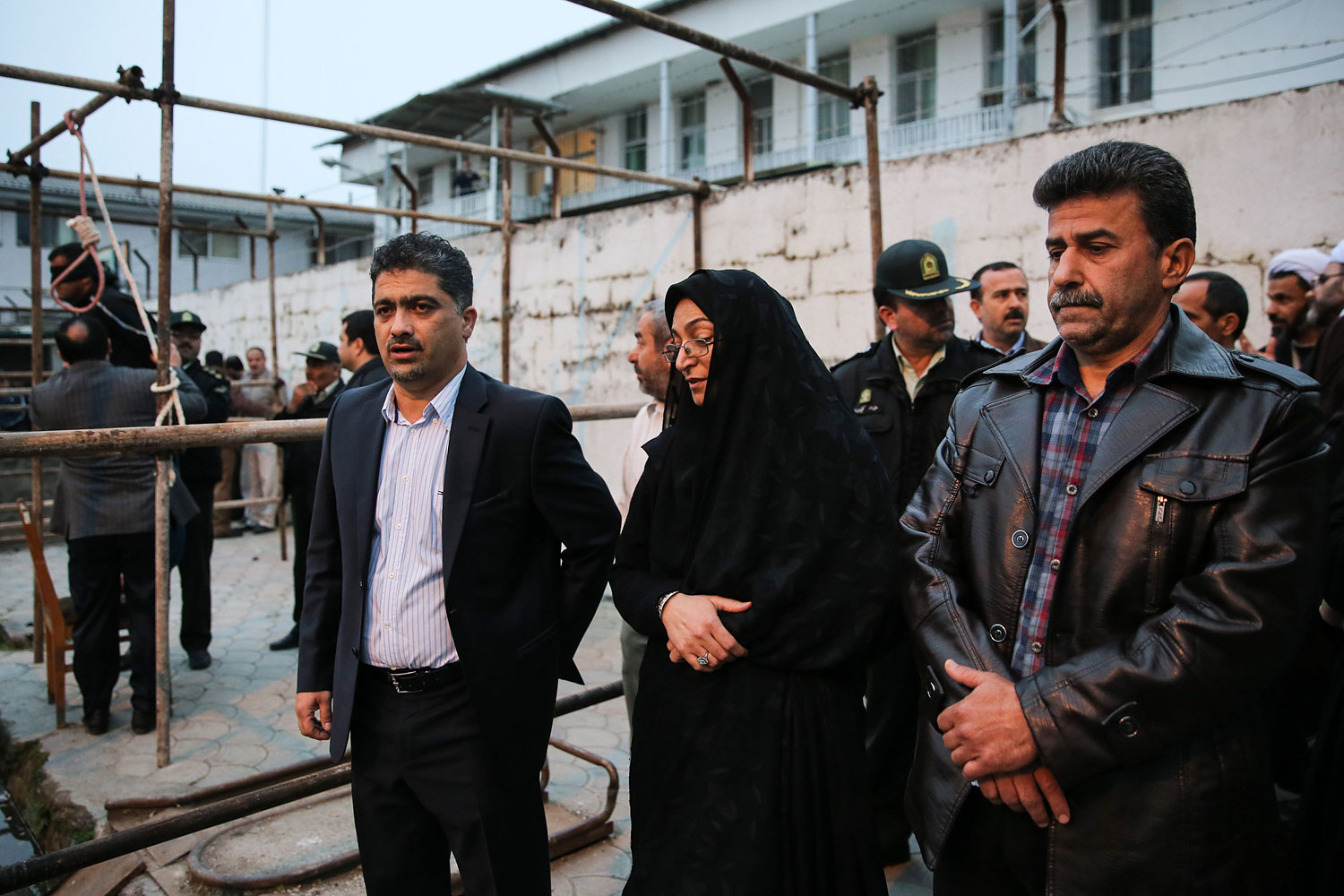 Samereh Alinejad, and Abdolghani Hosseinzadeh, the parents of Abdolah Hosseinzadeh, stand next to the gallows during Balal's execution ceremony in the northern city of Nowshahr on April 15, 2014.