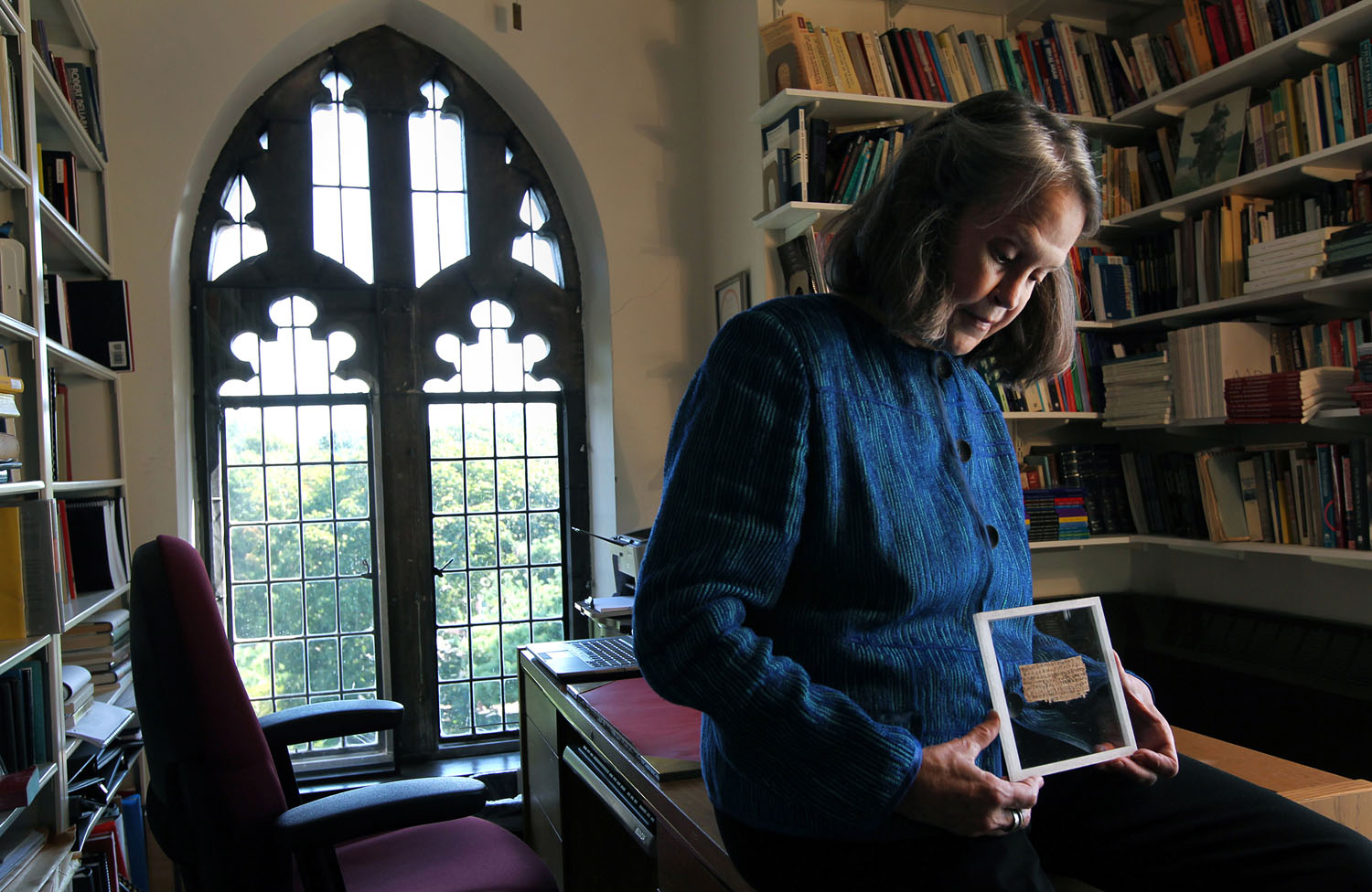 Karen L. King Hollis, Professor of Divinity at Harvard University, in her office with a papyrus fragment of the gospel of Jesus' wife. (Bill Greene—Boston Globe via Getty Images)