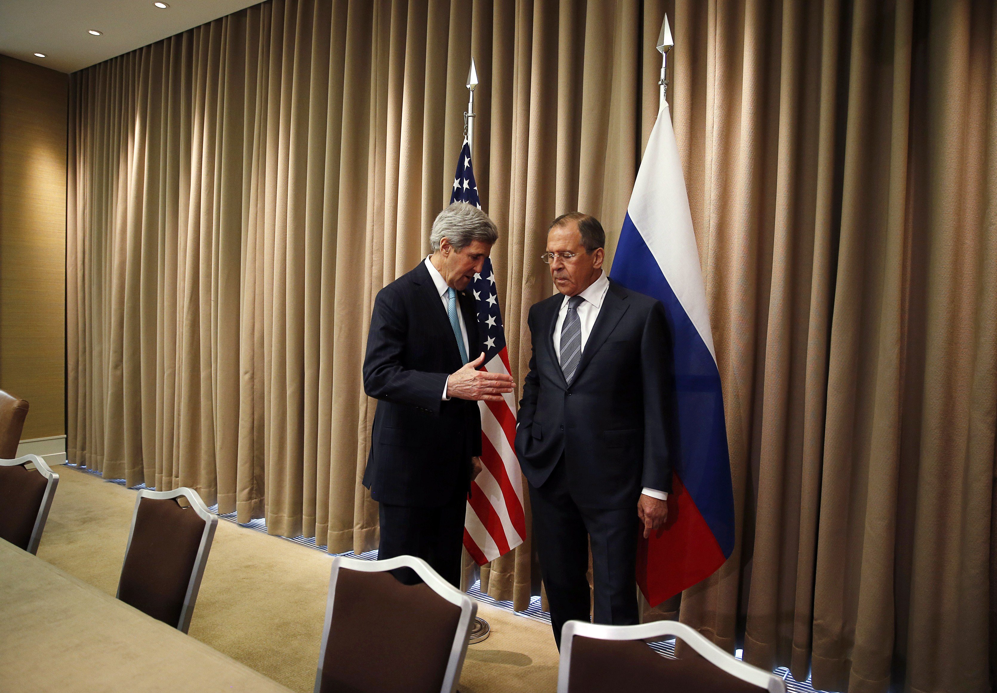 From left: U.S. Secretary of State John Kerry talks with Russian Foreign minister Sergei Lavrov at the start of a bilateral meeting to discuss the ongoing situation in Ukraine on April 17, 2014 in Geneva. (Jim Bourg—AFP/Getty Images)