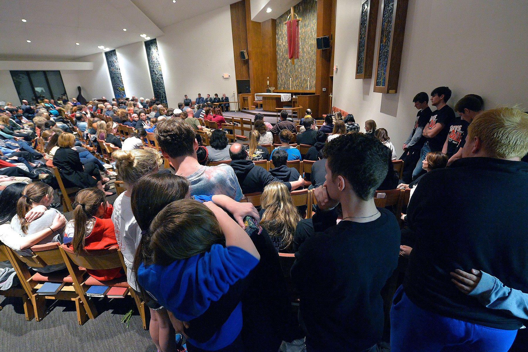Classmates of one of the victims hug during a prayer service for the victims of the Jewish Community Center shootings in Leawood, Kans., on April 13, 2014 (John Sleezer—Kansas City Star/MCT/Getty Images)