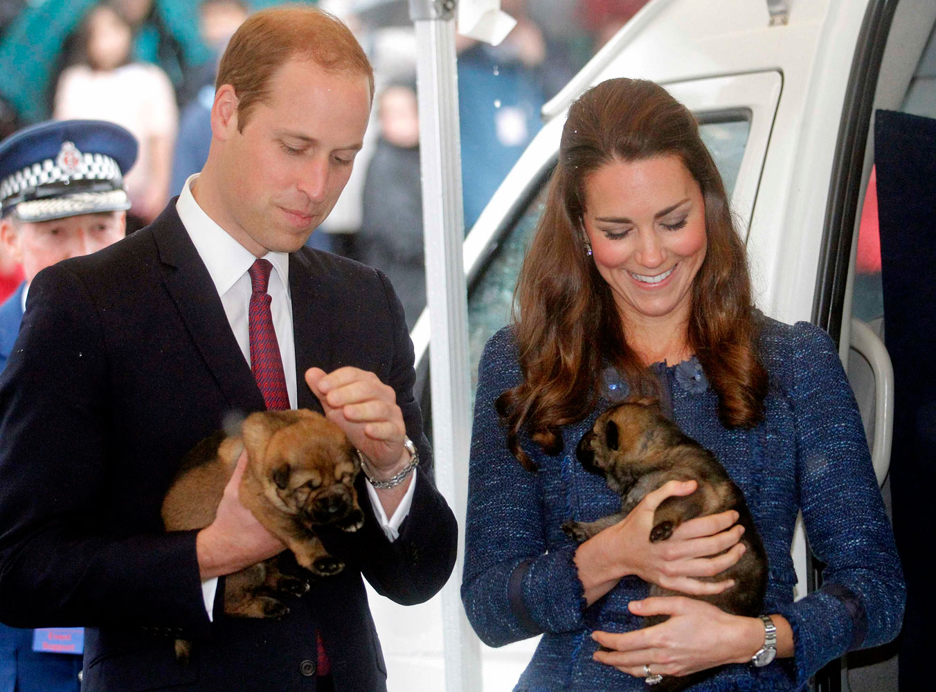 From left: Prince William, Duke of Cambridge, and Catherine, Duchess of Cambridge, hold police dog puppies at the Royal New Zealand Police College in Wellington, New Zealand, on April 16, 2014.