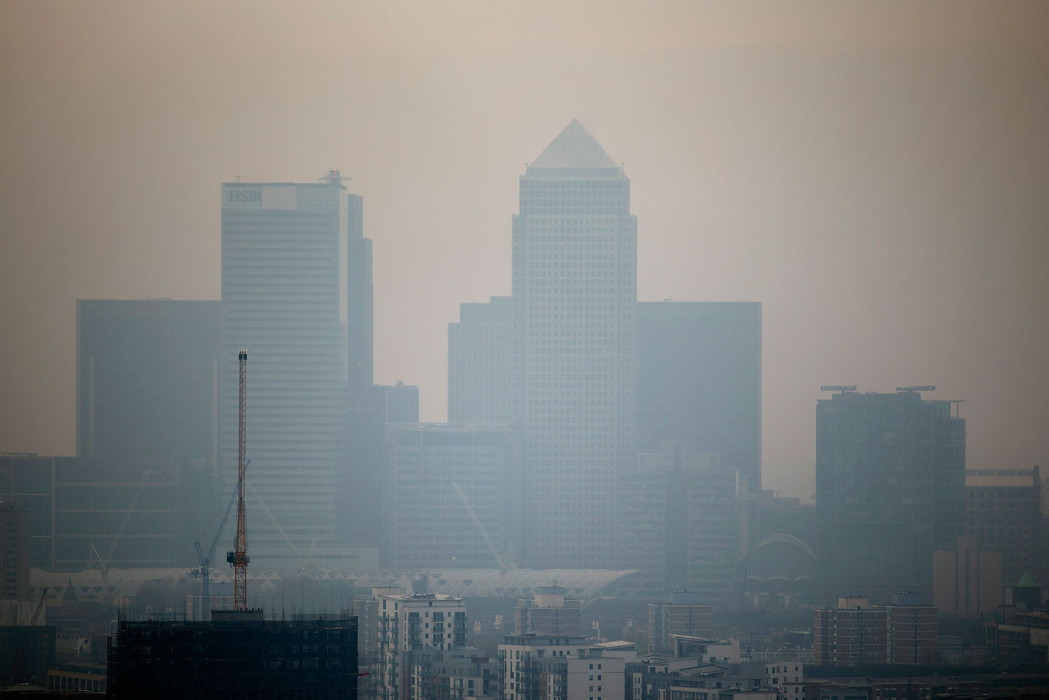 The skyscrapers of the Canary Wharf business district in London are shrouded in smog, April 2, 2014.