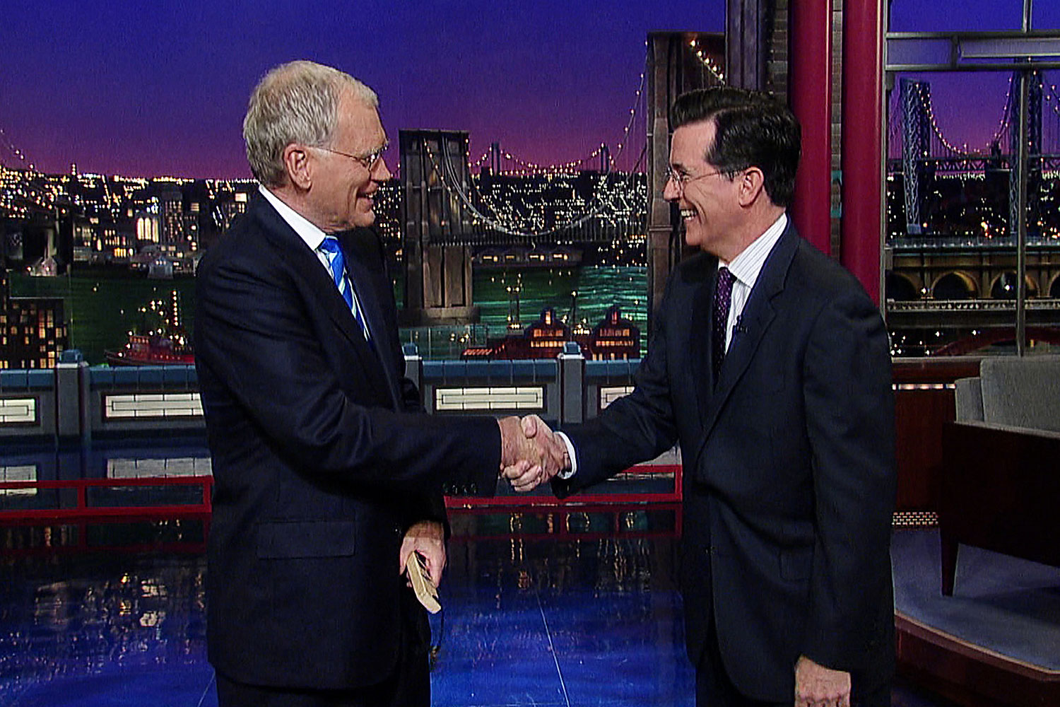 David Letterman shakes hands with fellow talk show host Stephen Colbert after Colbert comes by for a surprise visit on the Late Show, May 4, 2011. (Worldwide Pants Inc.)
