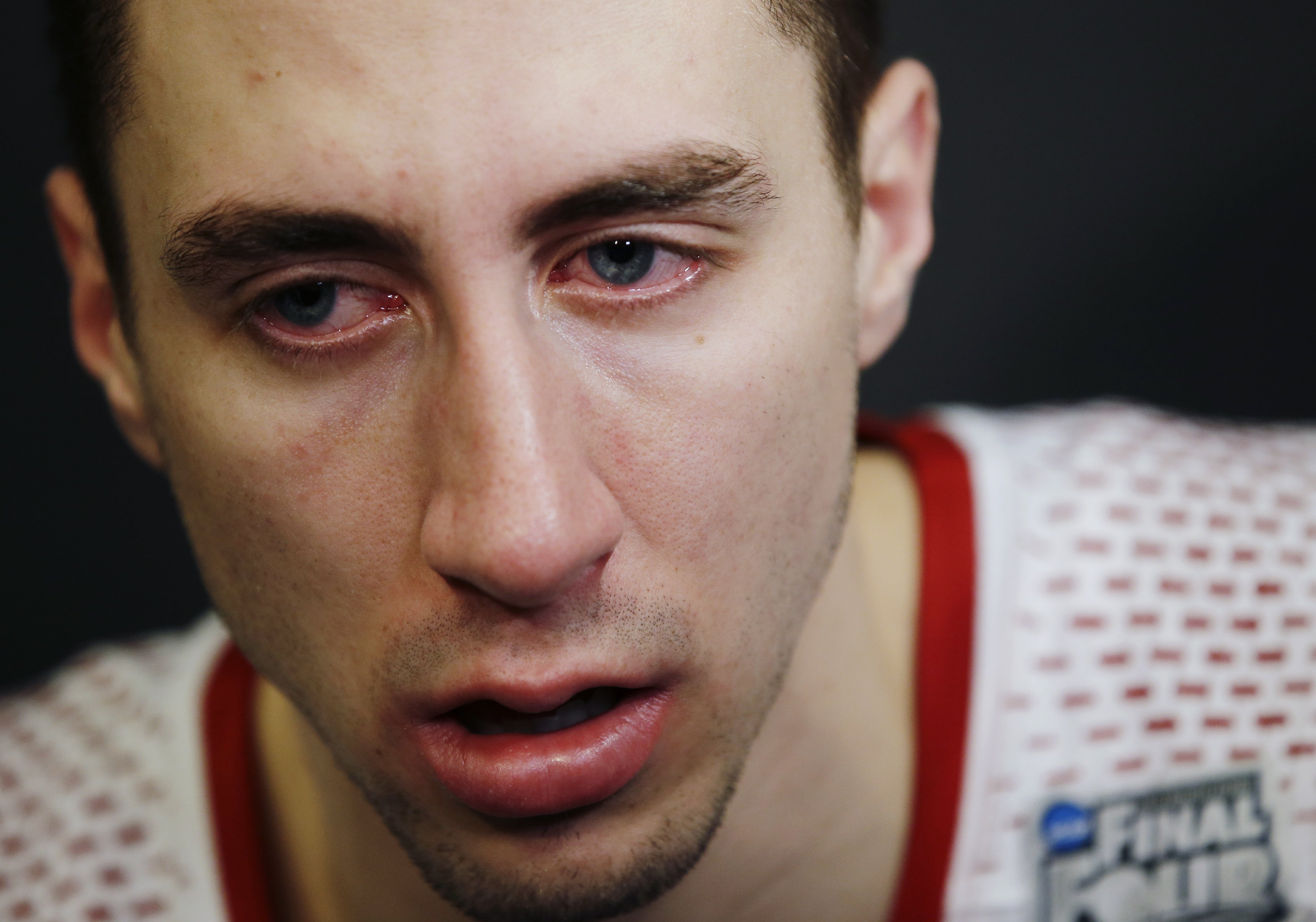 Wisconsin guard Josh Gasser sits dejected in the locker room after losing to Kentucky 74-73 at their NCAA Final Four tournament college basketball semifinal game Saturday, April 5, 2014, in Arlington, Texas.