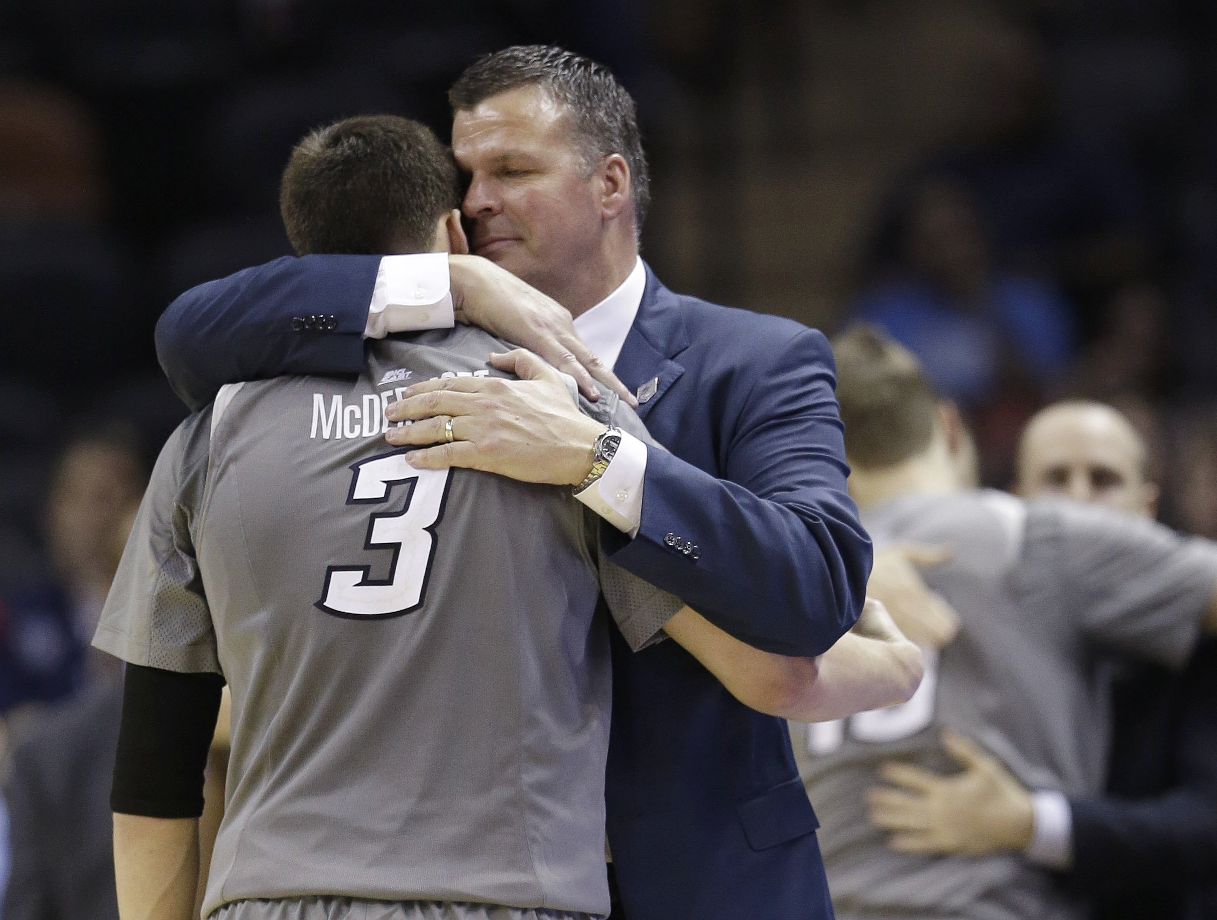 Creighton head coach Greg McDermott hugs his son Doug McDermott as he leaves the game during the final moments of their third-round loss to Baylor in the NCAA college basketball tournament Sunday, March 23, 2014, in San Antonio. Baylor won 85-55.