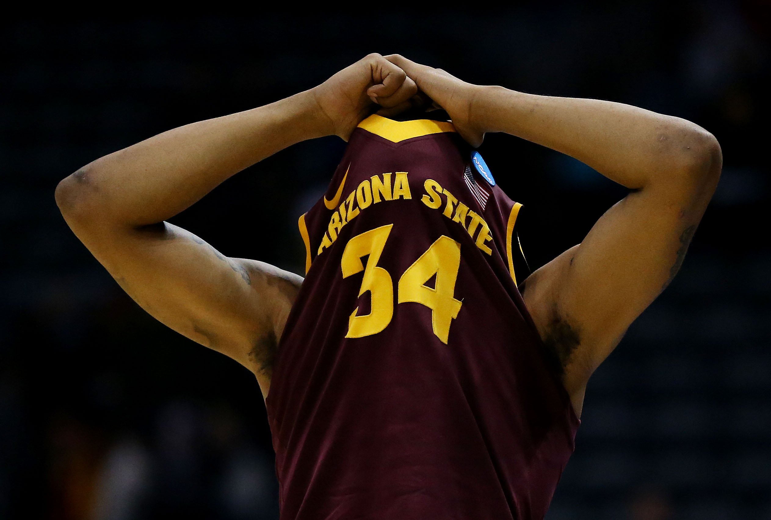Jermaine Marshall of the Arizona State Sun Devils hides his face during their 87-85 loss to the Texas Longhorns during the second round of the 2014 NCAA Men's Basketball Tournament at BMO Harris Bradley Center on March 20, 2014 in Milwaukee.