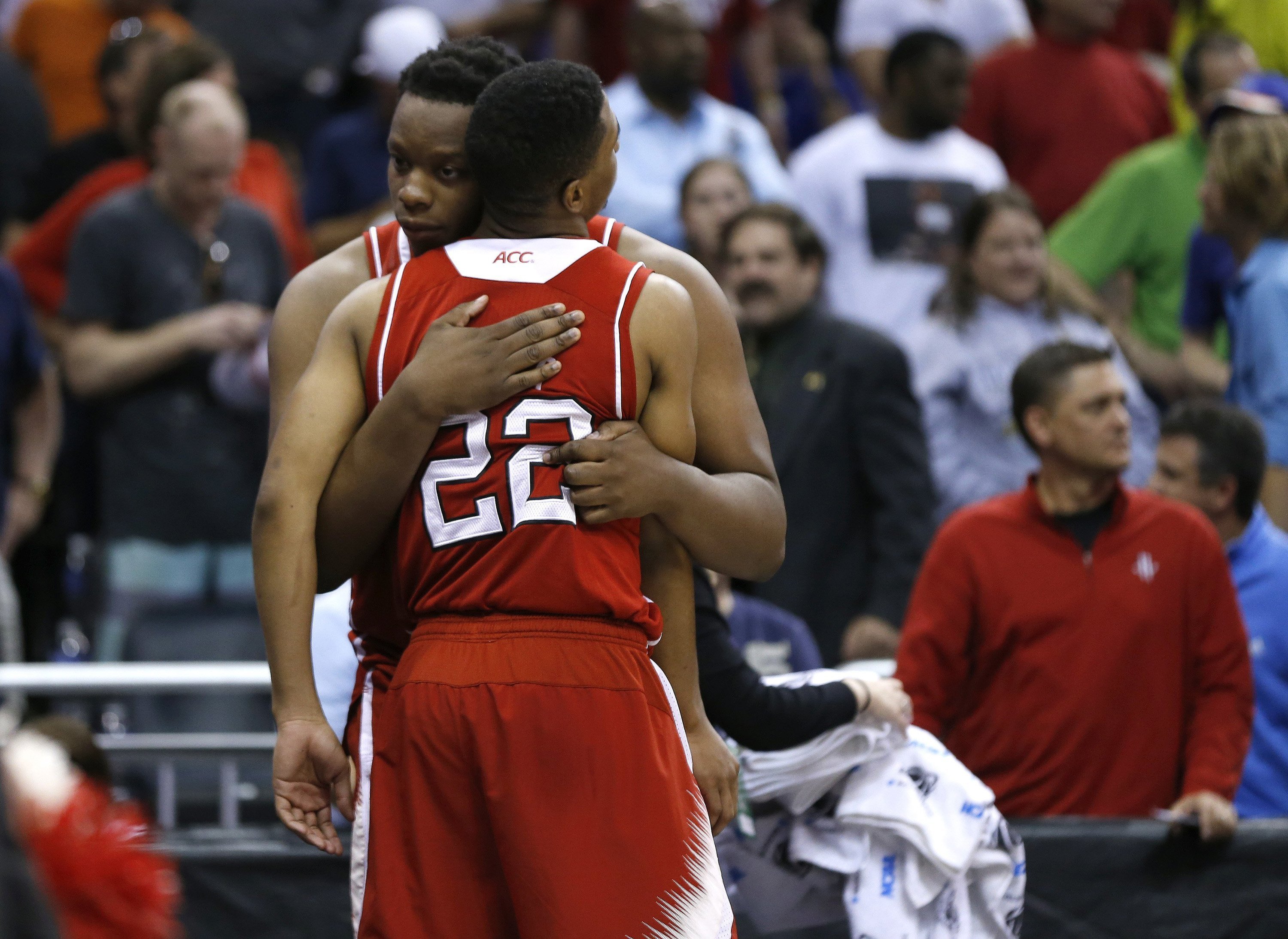 N.C. State Wolfpack's Beejay Anya hugs Ralston Turner after time expired during Saint Louis Billkens' 83-80 overtime victory in the second round of the NCAA Tournament at the Amway Center in Orlando, Fla., March 20, 2014.
