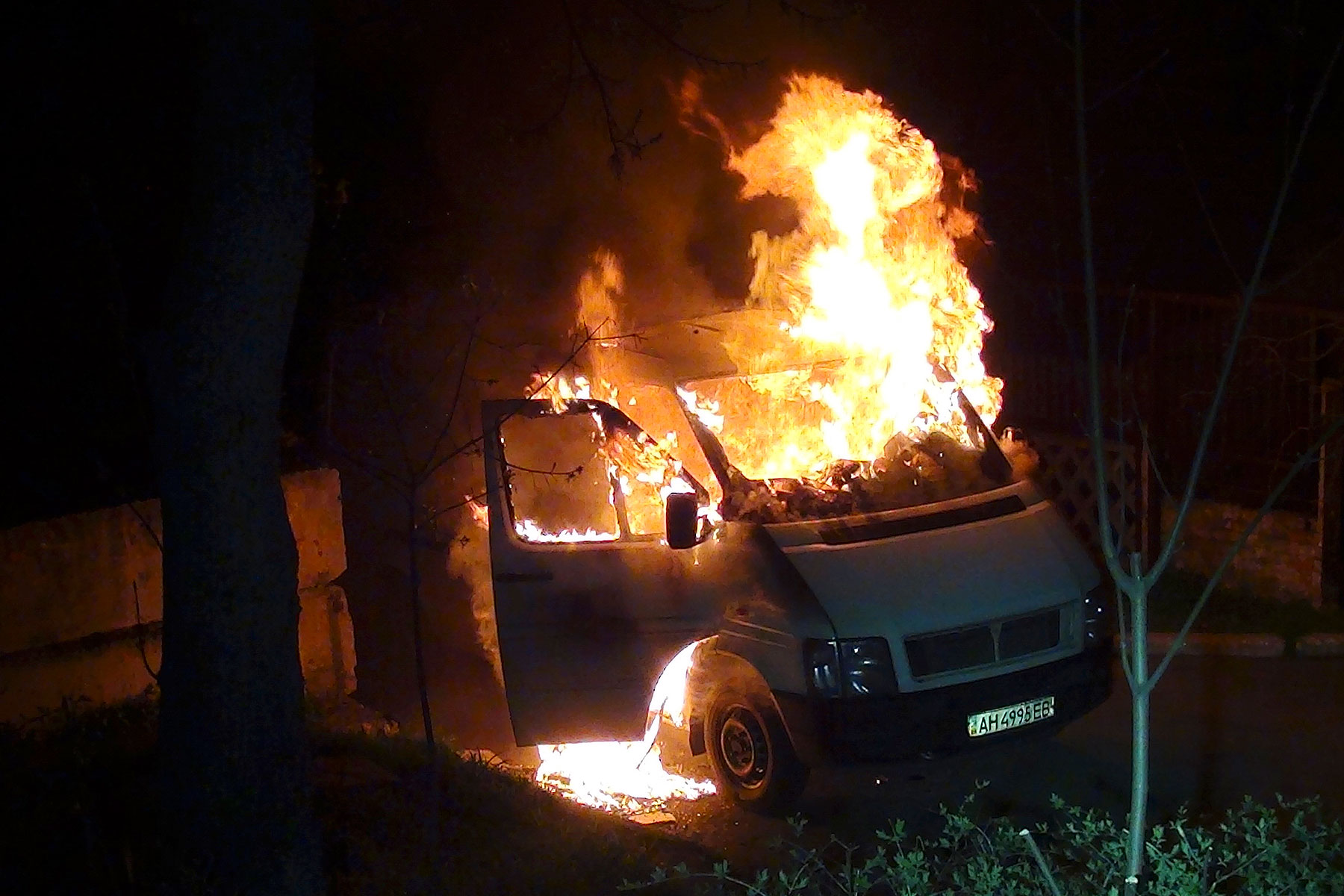 A minivan burns at the gates to a National Guard base in Mariupol, early Thursday, April 17, 2014