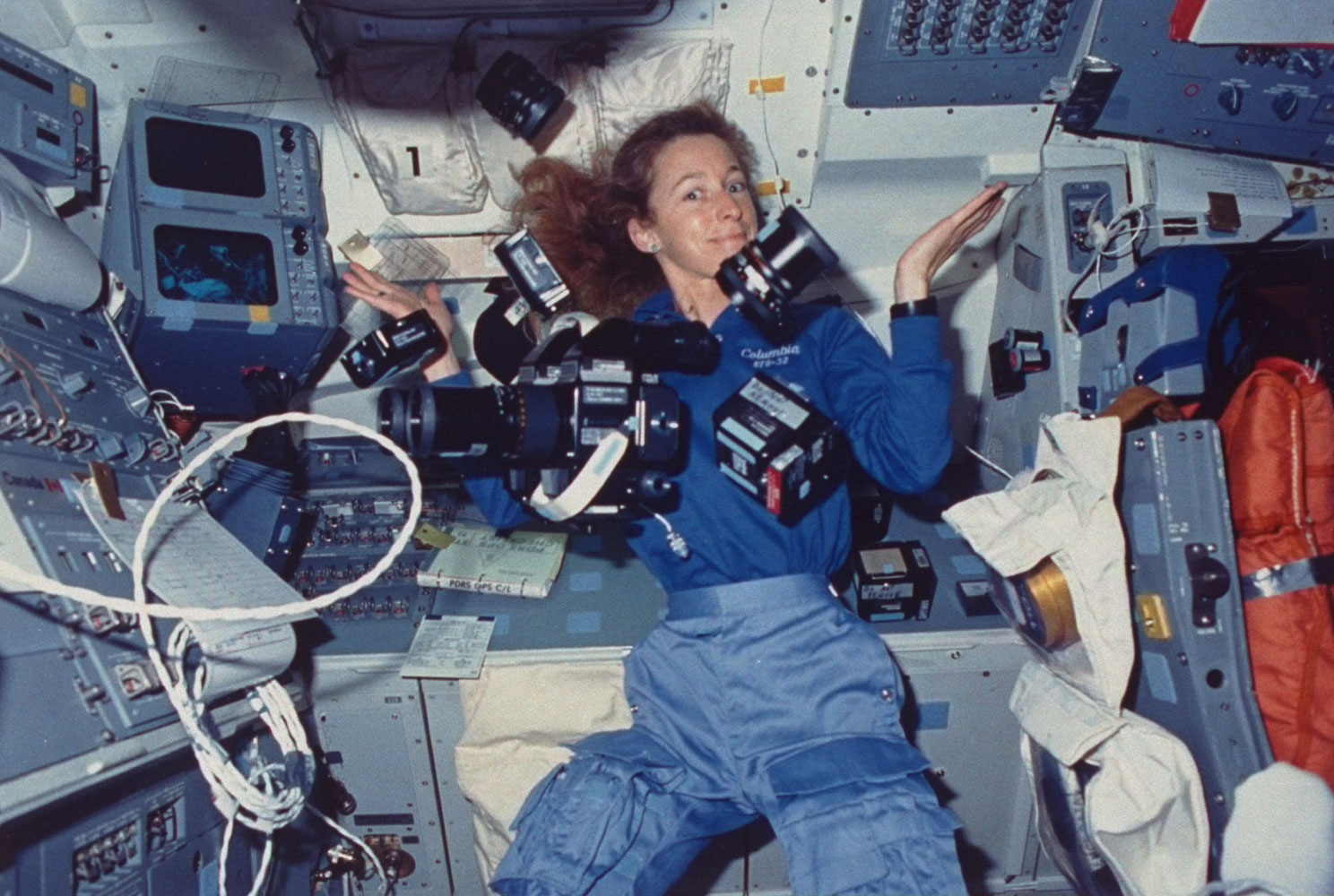 Astronaut Marsha Ivins, mission specialist aboard space shuttle Columbia, surrounded by cameras and supportive gear suspended by zero-gravity, on Jan. 1, 1990. Ivins flew in space five times.