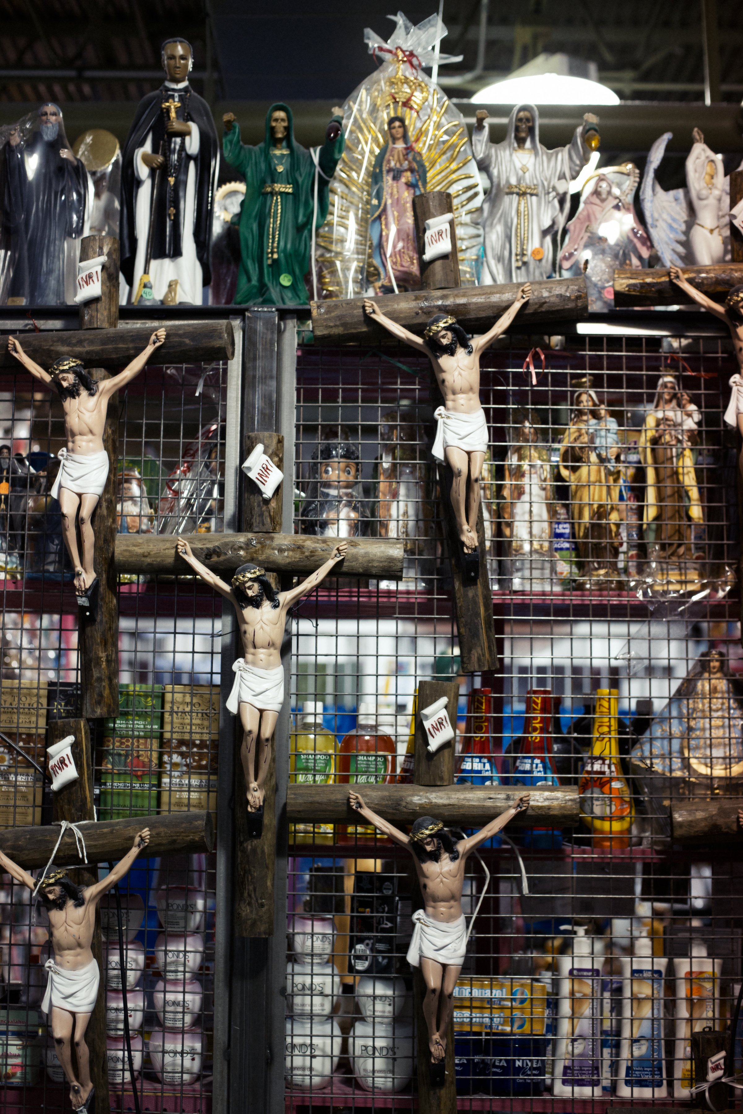A stall selling Mexican religious icons, Jesus, the Virgin de Guadalupe and the Santa Muerte. Stalls like this are popular in Mexican markets, largely catering to those who feel in need of spiritual cleansing.