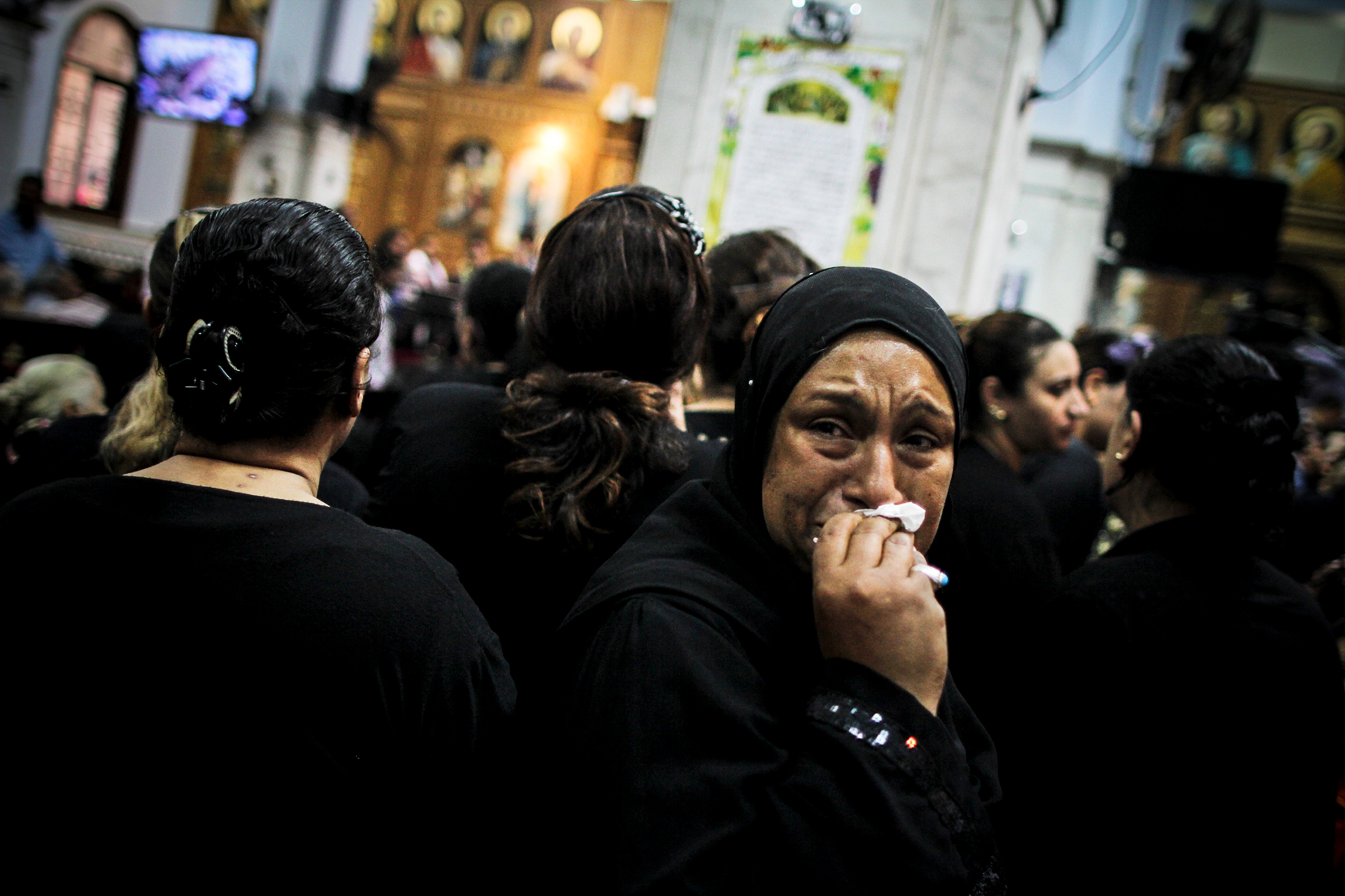 <strong>Escalating fear</strong> A mourner at the funeral of four Egyptian Christians killed in a drive-by shooting (Mosa'ab Elshamy)