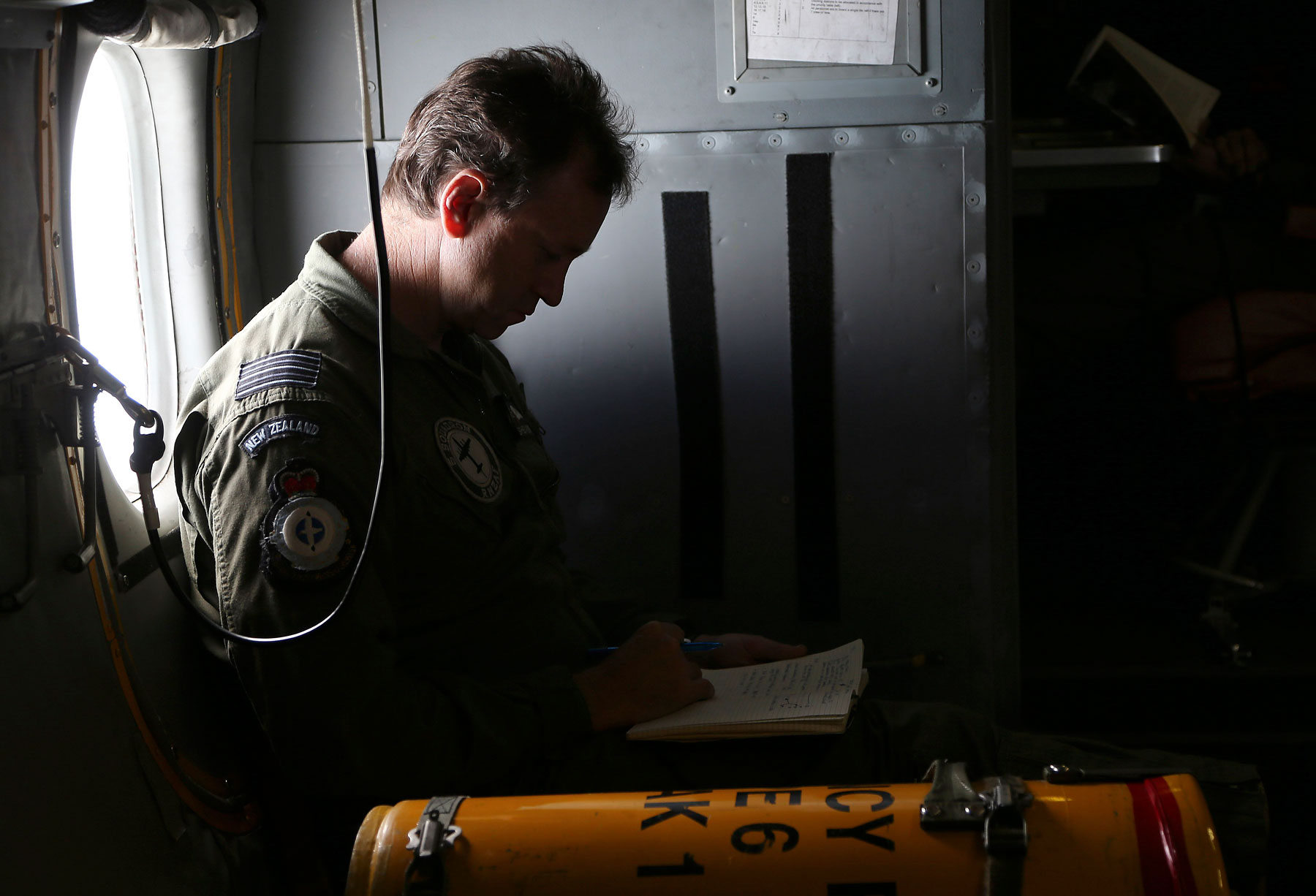 Wing commander Rob Shearer, captain of the Royal New Zealand Air Force P3 Orion, reads through his notes before reaching the search area for missing Malaysia Airlines Flight MH370 in the southern Indian Ocean, near the coast of Western Australia