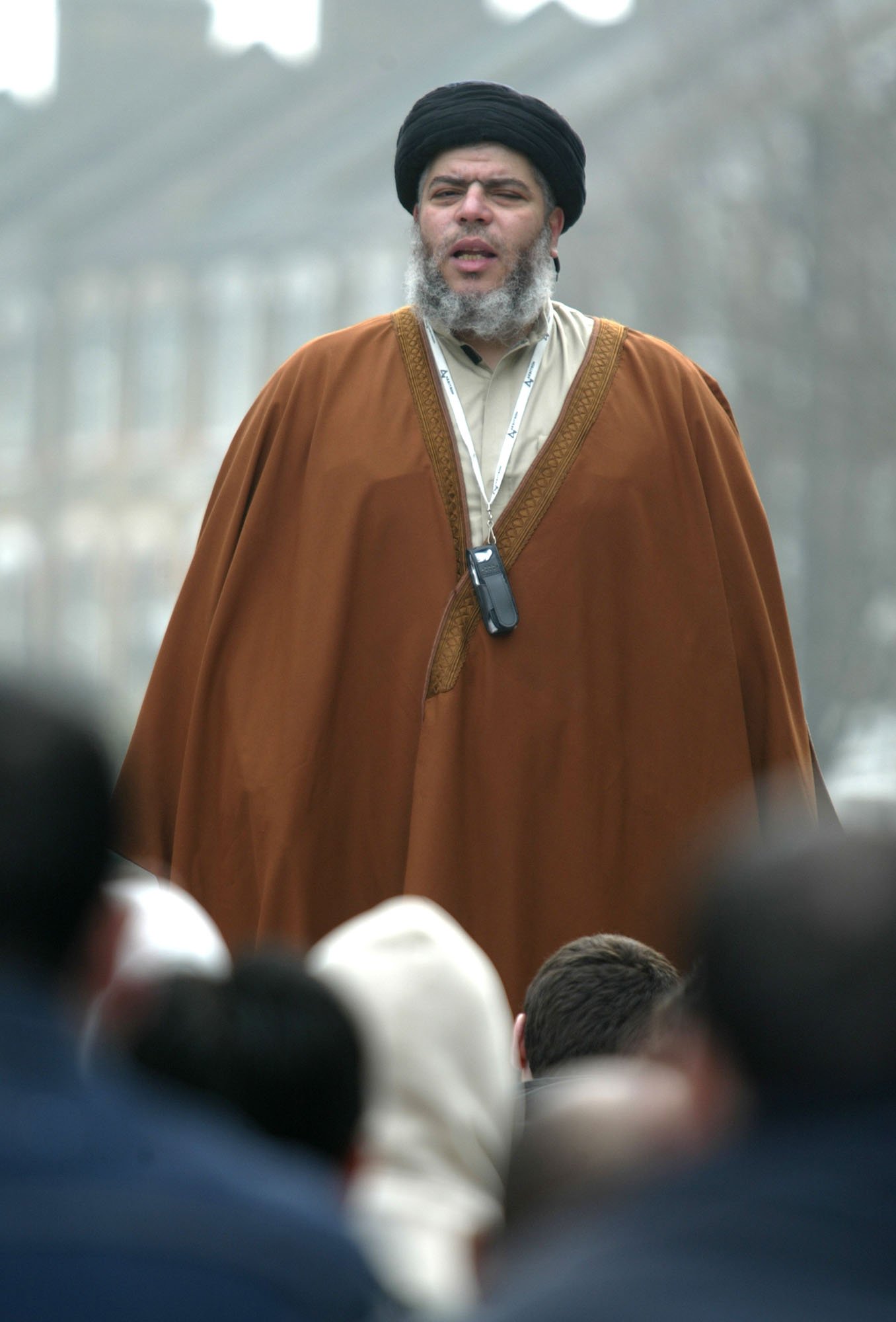 Muslim cleric Mustafa Kamel Mustafa prays in a street outside his Mosque in north London, on March 28, 2003.