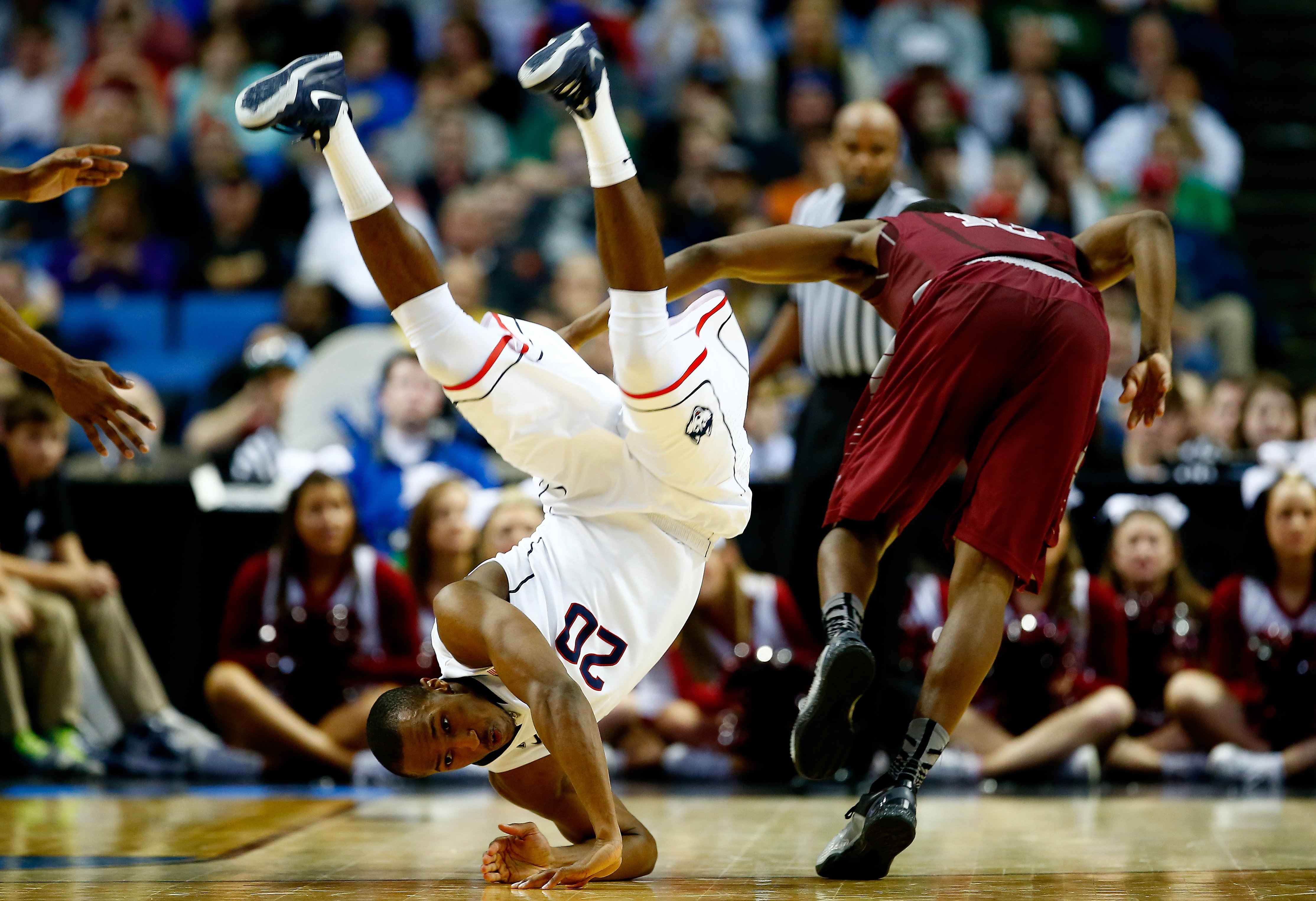 Lasan Kromah of the Connecticut Huskies and Langston Galloway of the Saint Joseph's Hawks collide during the second round of the 2014 NCAA Men's Basketball Tournament at the First Niagara Center on March 20, 2014 in Buffalo, N.Y.