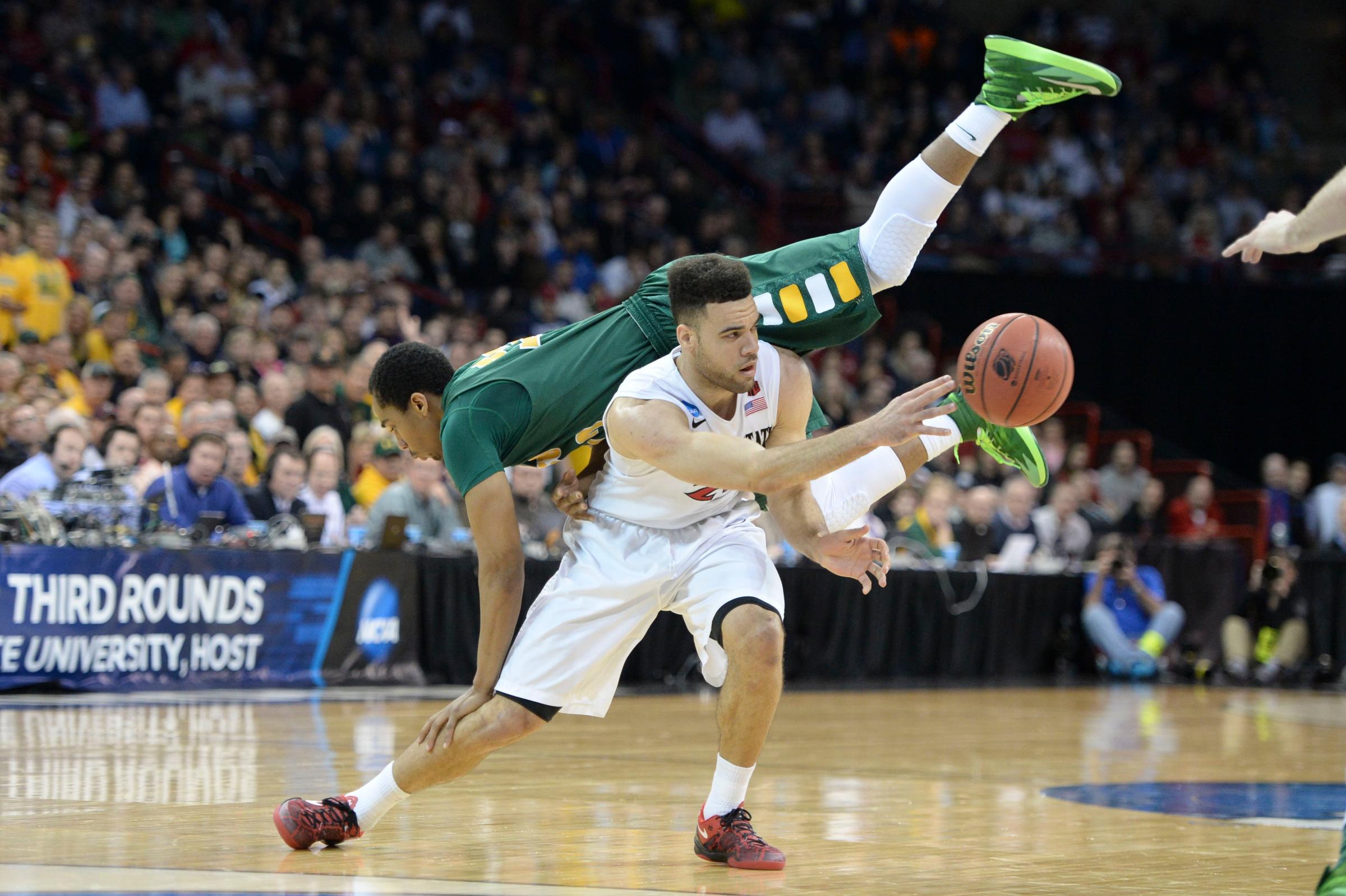 North Dakota State Bison guard Lawrence Alexander falls over San Diego State Aztecs forward JJ O'Brien in the second half of a men's college basketball game during the third round of the 2014 NCAA Tournament at Veterans Memorial Arena, March 22, 2014.