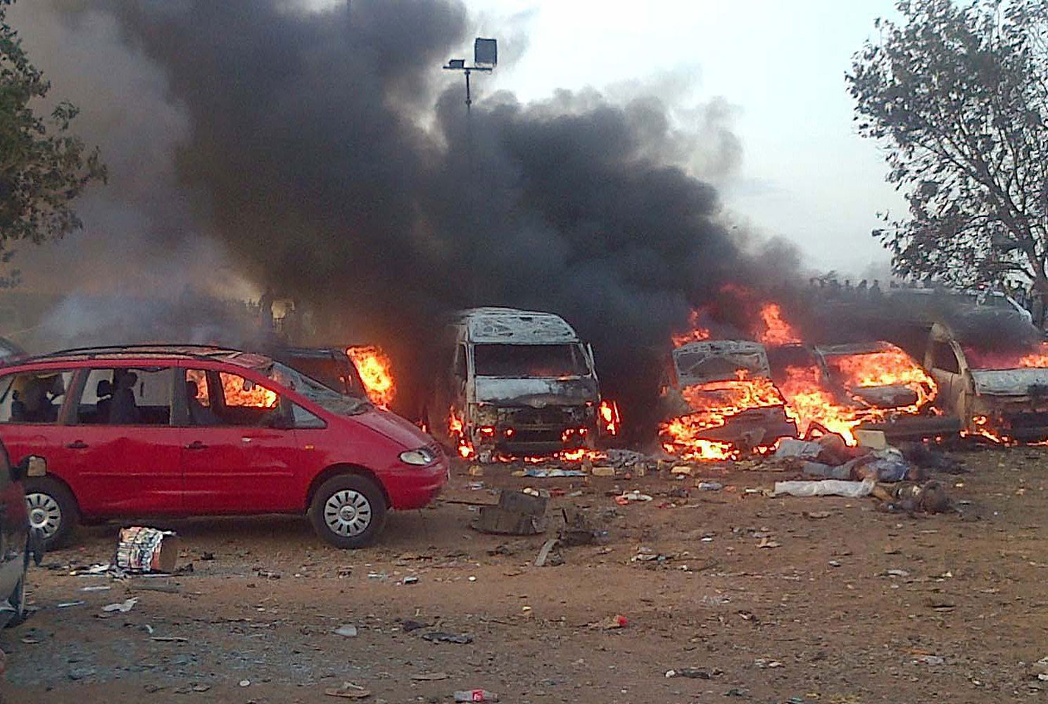 Vehicles burn after an attack in Abuja on April 14, 2014.