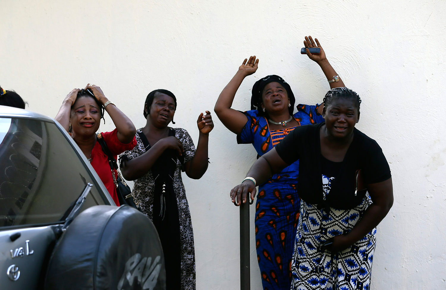 Bystanders react as victims of a bomb blast arrive at the Asokoro General Hospital in Abuja April 14, 2014.