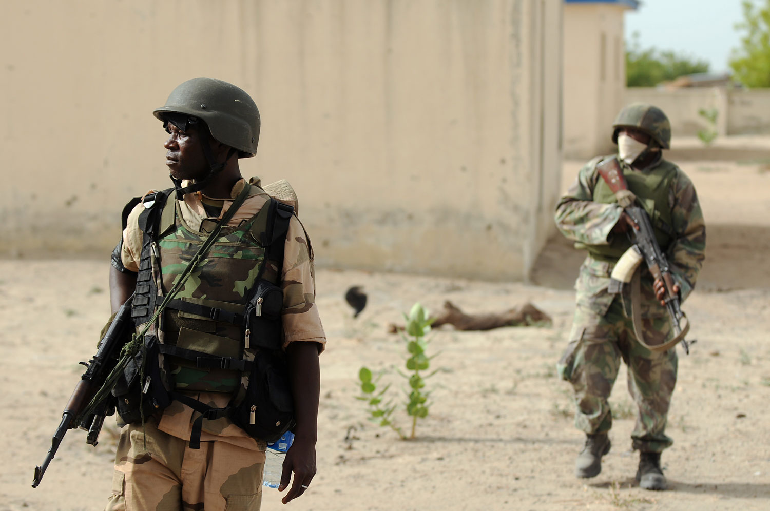 Nigerian soldiers patrol in the north of Borno state close to a Islamist extremist group Boko Haram former camp on June 5, 2013 near Maiduguri. 