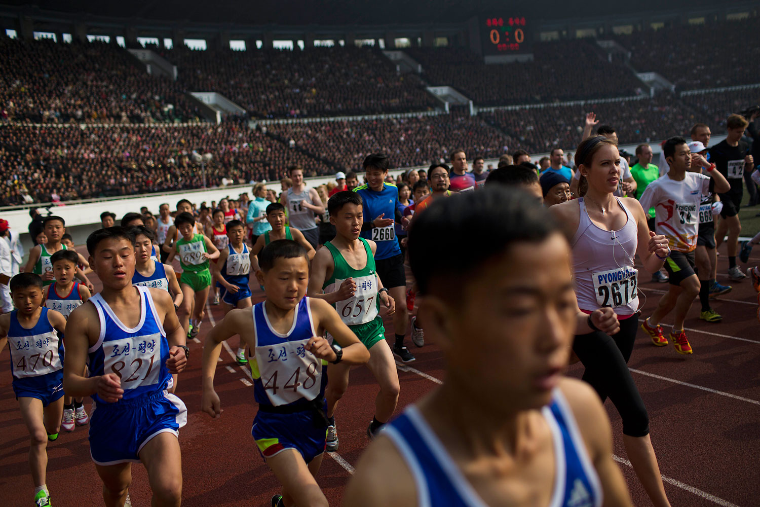 Runners take off from the starting line inside Kim Il Sung Stadium at the beginning of the Mangyongdae Prize International Marathon in Pyongyang, North Korea on April 13, 2014.
