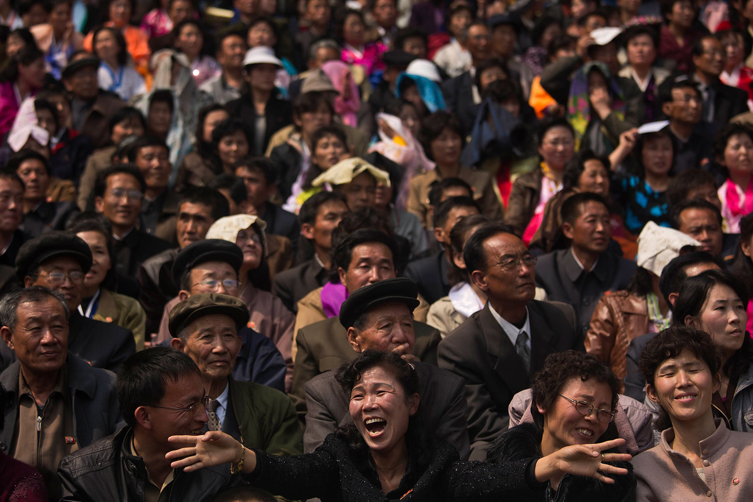 North Korean spectators watch and cheer from the stands of Kim Il Sung Stadium as runners arrive at the finish of the Mangyongdae Prize International Marathon in Pyongyang on April 13, 2014.