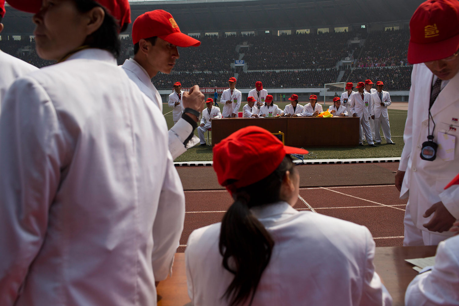 North Korean race officials stand at the finish line inside Kim Il Sung Stadium during the running of the Mangyongdae Prize International Marathon in Pyongyang on April 13, 2014.