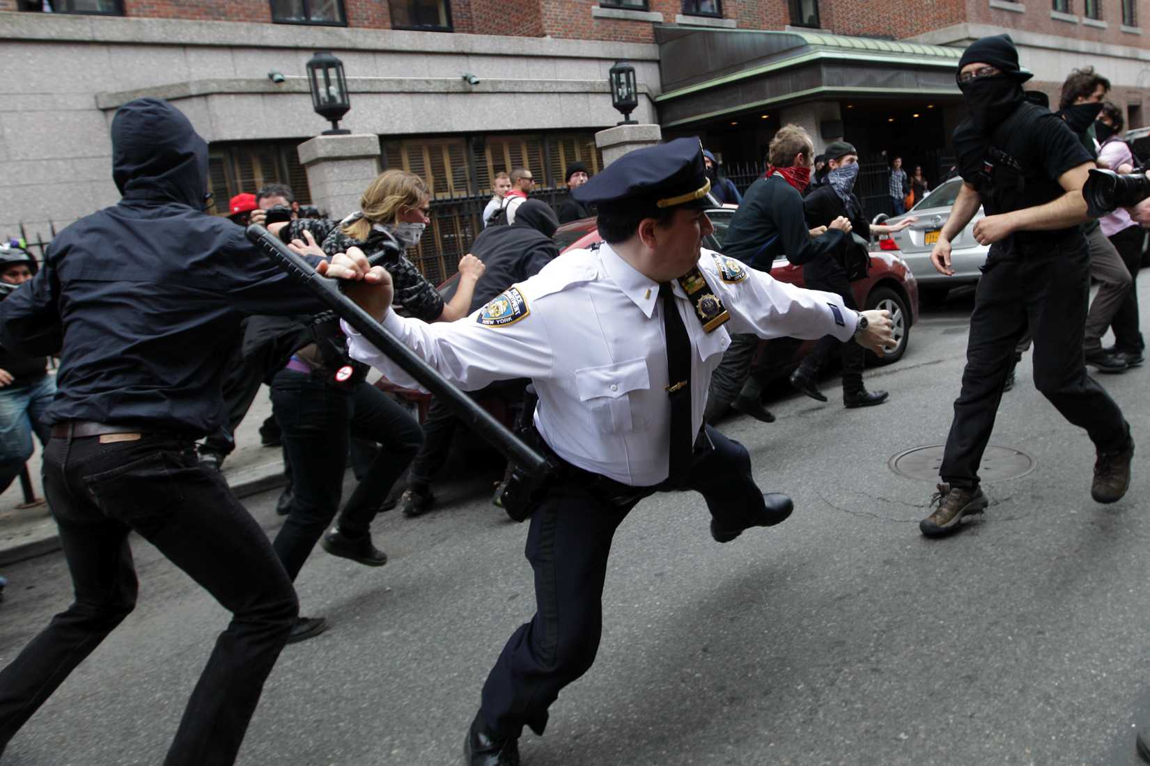 A police lieutenant swings his baton at Occupy Wall Street activists in New York City on May 1, 2012. (Mary Altaffer—AP Photo)