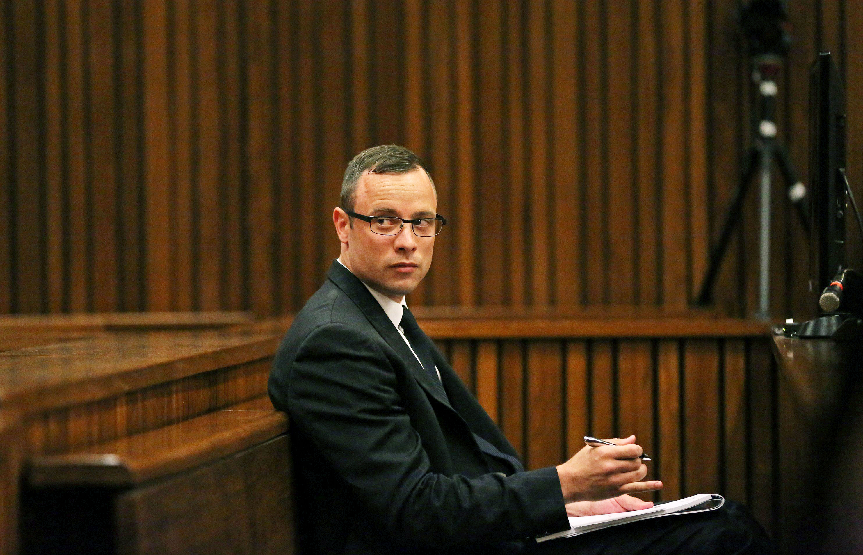 Paralympic track star Oscar Pistorius sits in the dock during his trial for the murder of his girlfriend Reeva Steenkamp, at the North Gauteng High Court in Pretoria, on March 25, 2014.