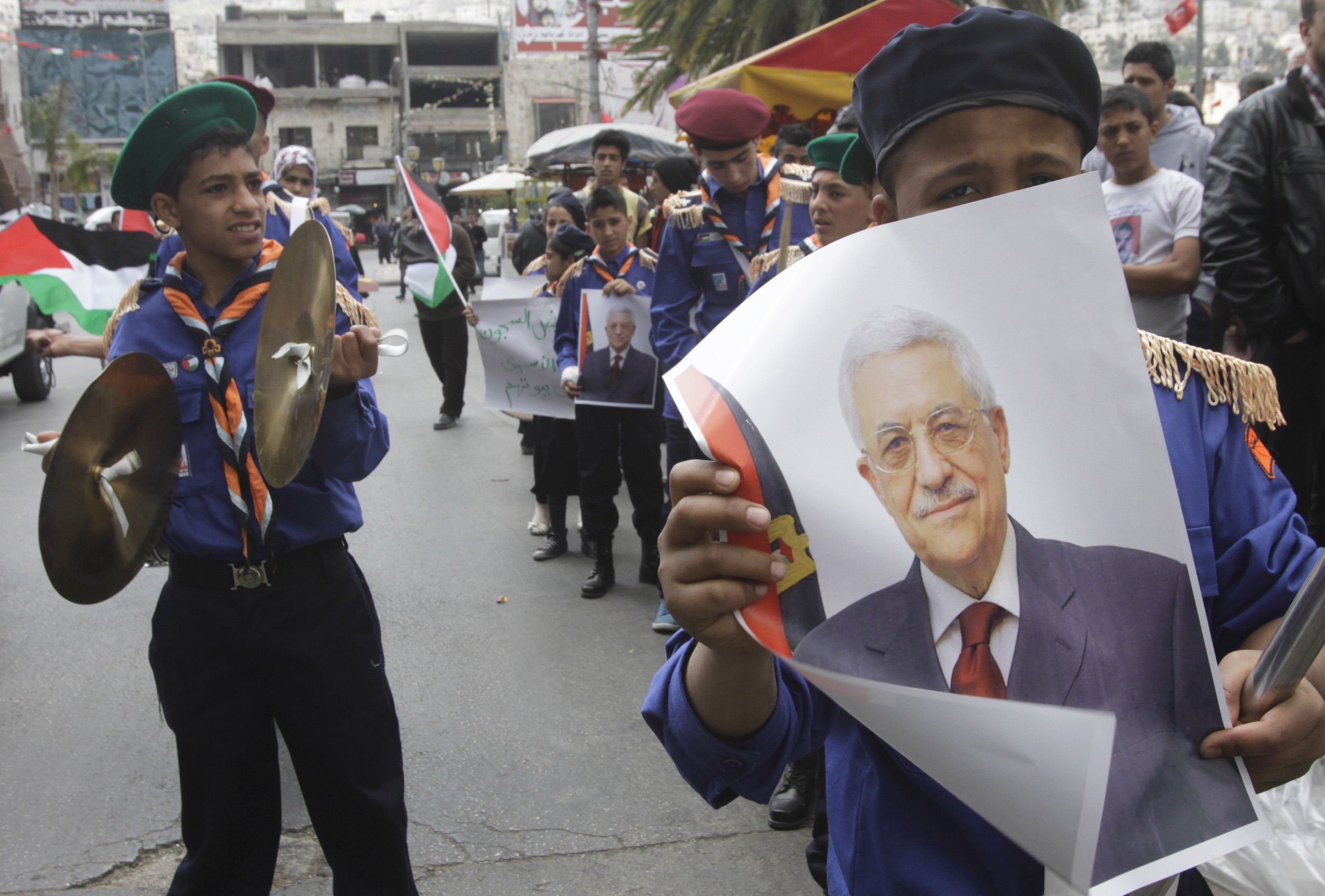 Scouts hold posters of Palestinian President Mahmoud Abbas during a Fatah rally in the West Bank city of Nablus on April 2, 2014 (Abed Omar Qusini—Reuters)