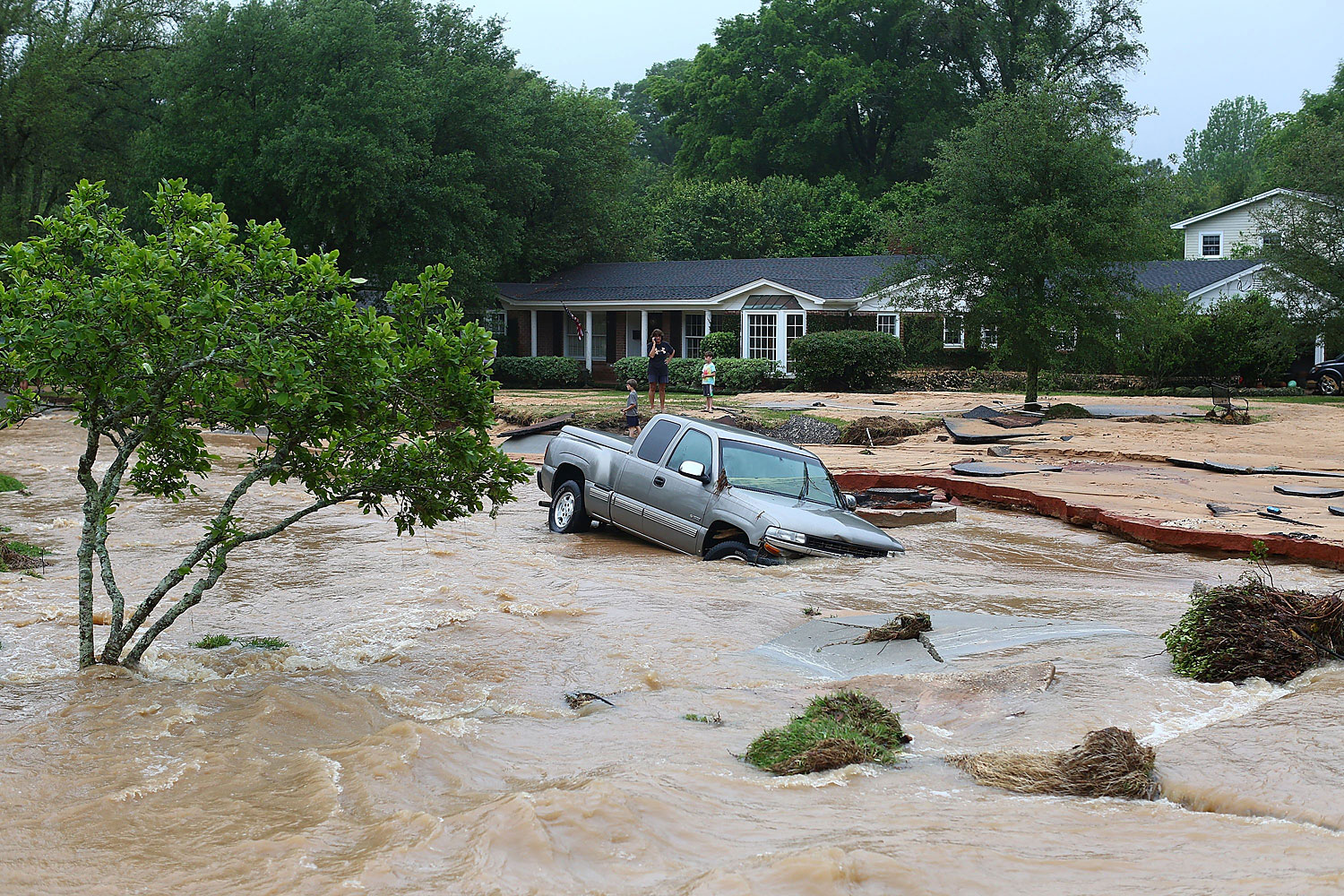 A truck is stuck in the middle of flooded Piedmont Street in the Cordova Park neighborhood after it washed out due to heavy rains on April 30, 2014 in Pensacola, Fla. (Marianna Massey—Getty Images)