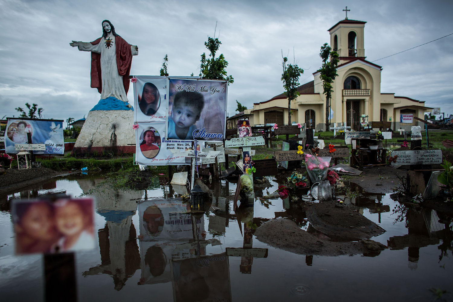 Crosses and personal items are seen at the makeshift mass grave site at San Joaquin Parish on April 16, 2014 in Tacloban.
