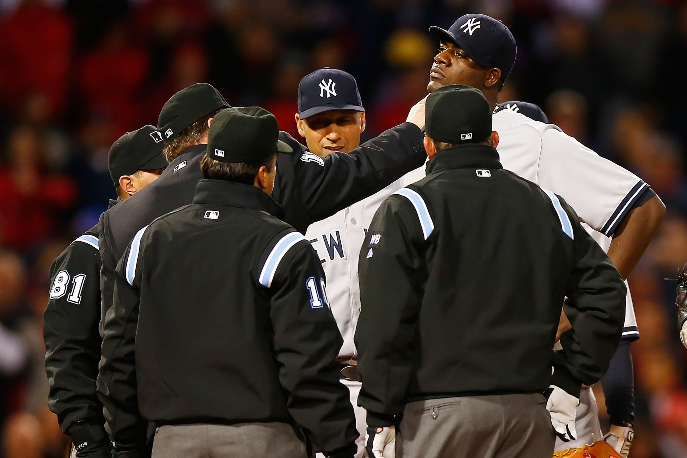 Umpires check Michael Pineda for a foreign substance as Derek Jeter looks on.