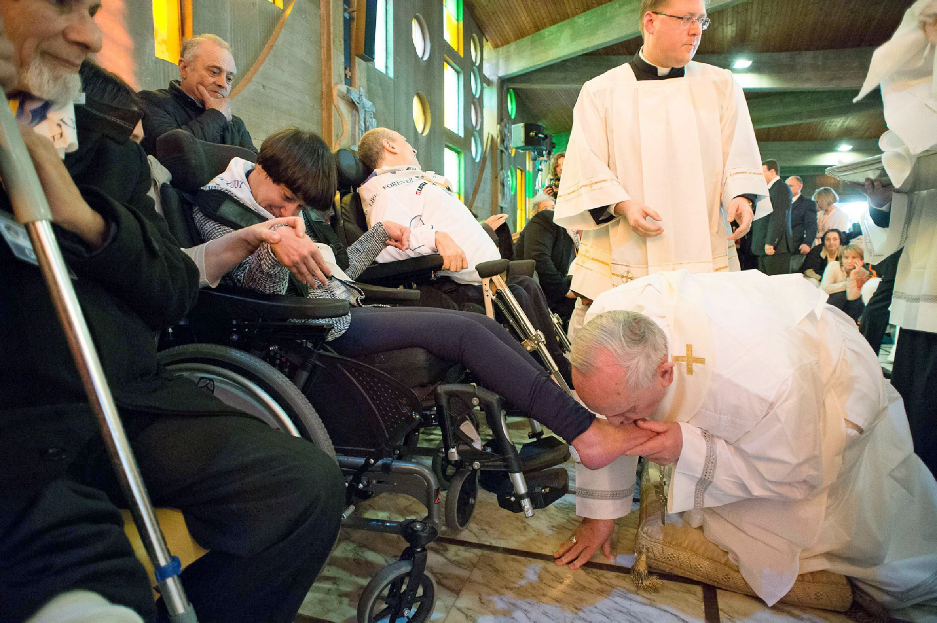 Pope Francis performs the traditional washing of the feet at the Don Carlo Gnocchi Foundation in Rome, on April 17, 2014. (Osservatore Romano/EPA)