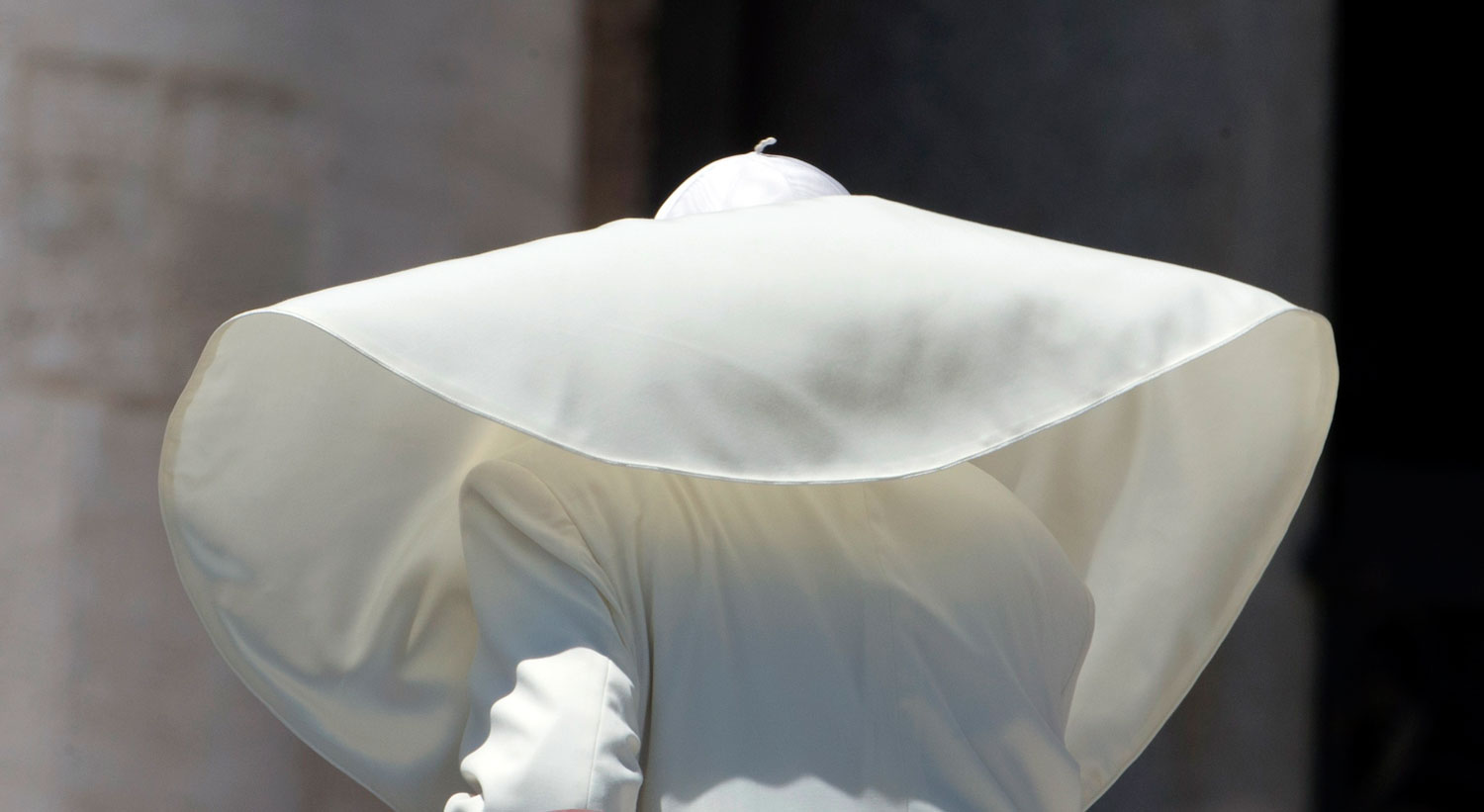 A gust of wind blows Pope Francis mantle as he  leaves St. Peter's square at the Vatican after his weekly general audience Wednesday, June 12, 2013. (AP Photo/Alessandra Tarantino)