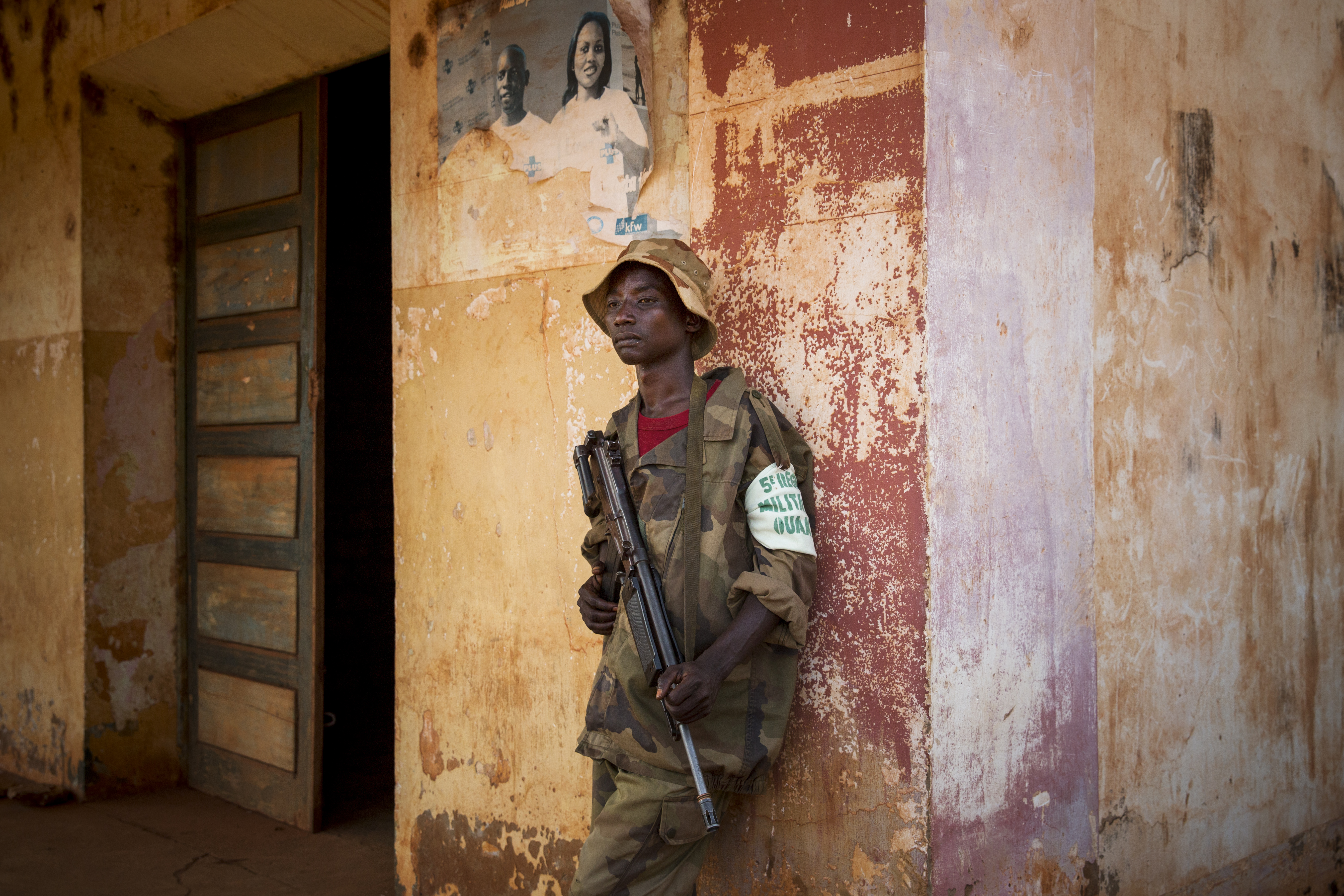 Apr. 13, 2014. Bambari. An ex-Séléka fighter stands watch outside his base.