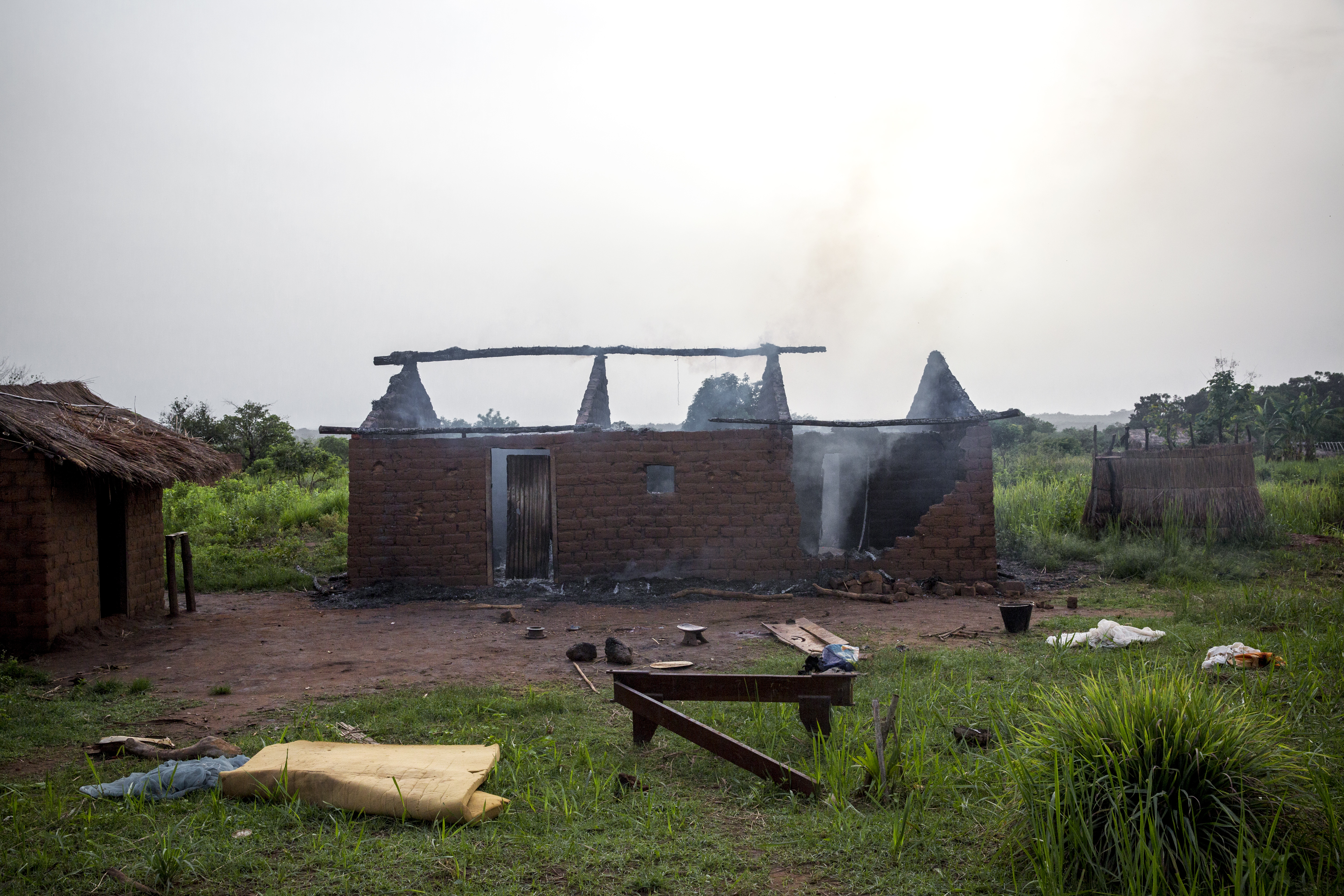 Apr. 14, 2014. Gulinga, near Grimari. A house burns where ex-Séléka fighters had killed three christians—two men and a woman—and reportedly kidnapped a fourth just 30 minutes earlier, accusing them of being anti-balaka. An ex-Séléka colonel who admitted to the killing said the woman was collateral damage, of sorts, and that the men were the targets.