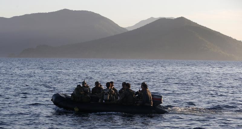 Members of Philippine marines are transported on rubber boat from a patrol ship, after mission at disputed Second Thomas Shoal, as they return to naval forces camp in Palawan