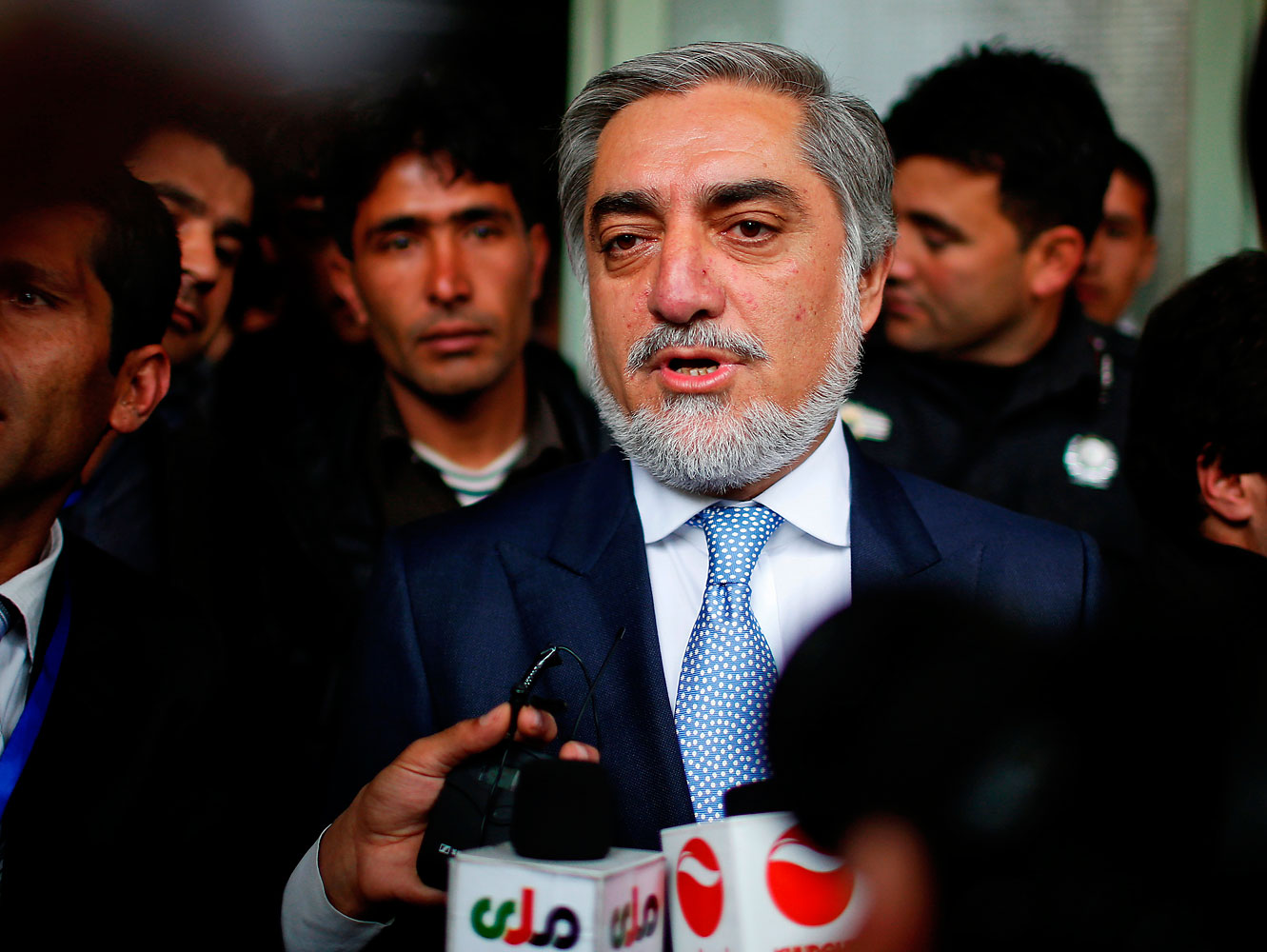 Afghan presidential candidate Abdullah Abdullah speaks to the media after voting at a polling station in Kabul