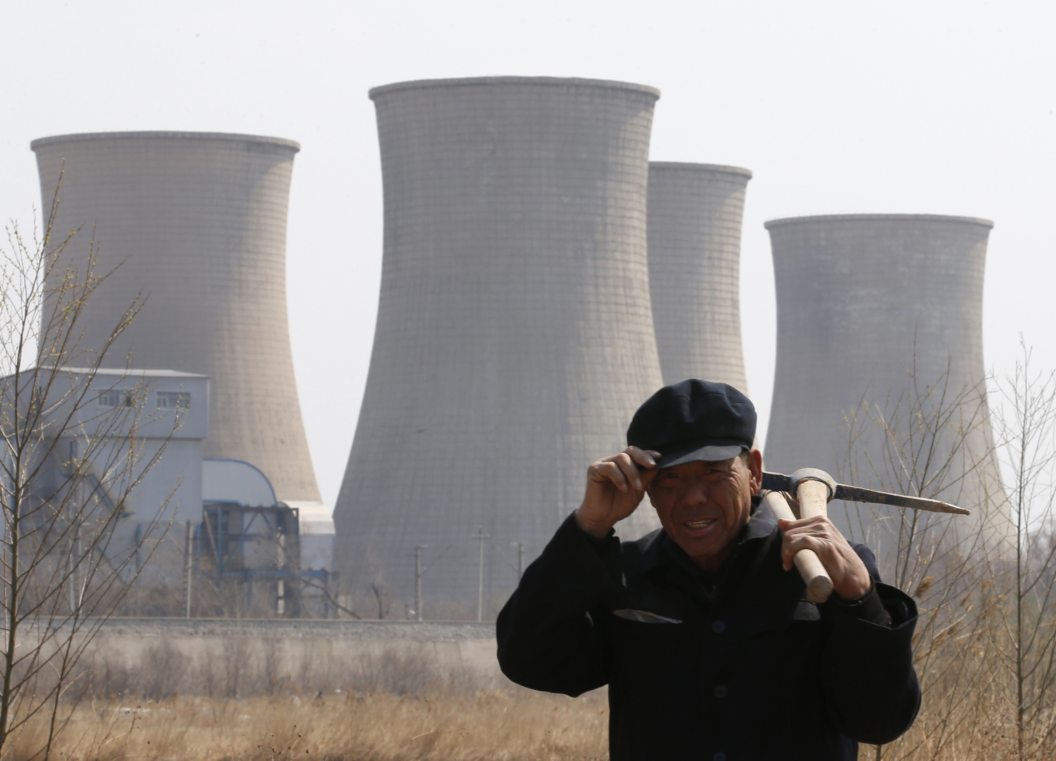 A worker walks past a steel factory in Beijing on April 1, 2013 (Kim Kyung Hoon—Reuters)