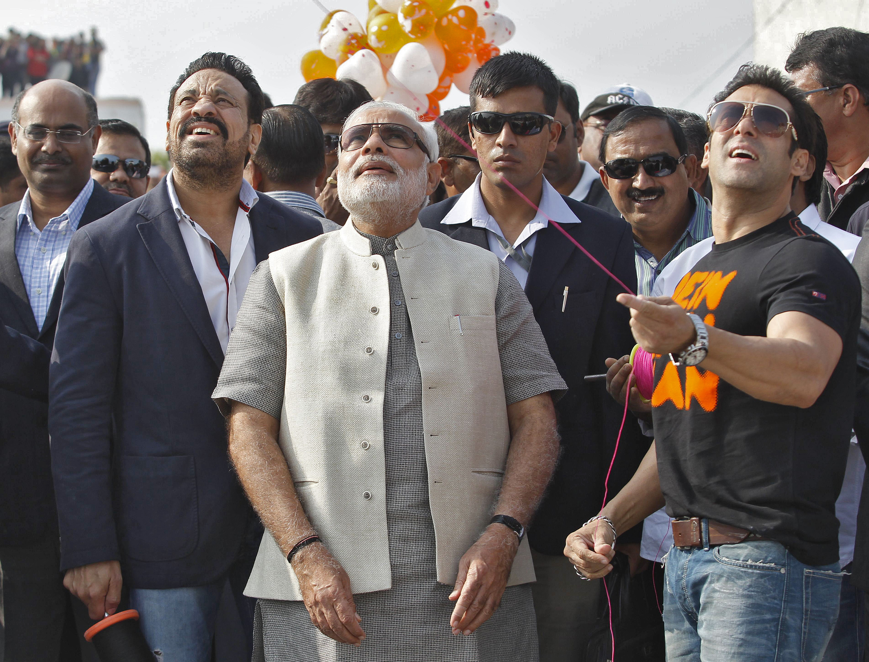 Bollywood actor Salman Khan (R) flies a kite as Hindu nationalist Narendra Modi (C), prime ministerial candidate for India's main opposition Bharatiya Janata Party (BJP) and Gujarat's chief minister, watches during a kite flying festival in the western Indian city of Ahmedabad January 14, 2014. (Amit Dave—Reuters)