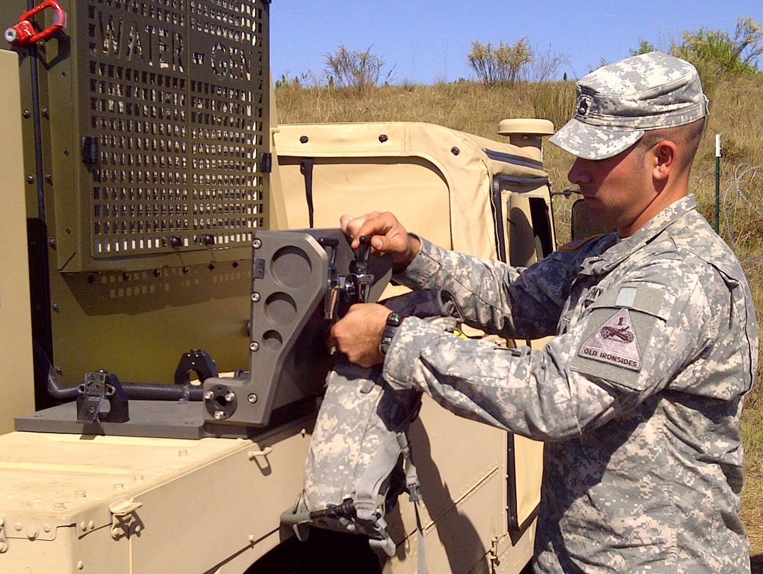 A U.S. Army member pours water generated by Water-Gen's Atmospheric Water-Generation Unit during an exercise. (Courtesy Water-Gen)